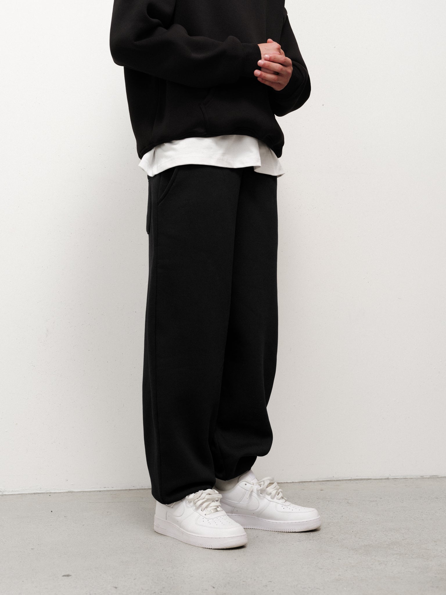 Black cozy sweatpants from Sweats UK, featuring a relaxed fit and soft fabric for comfortable casual wear.