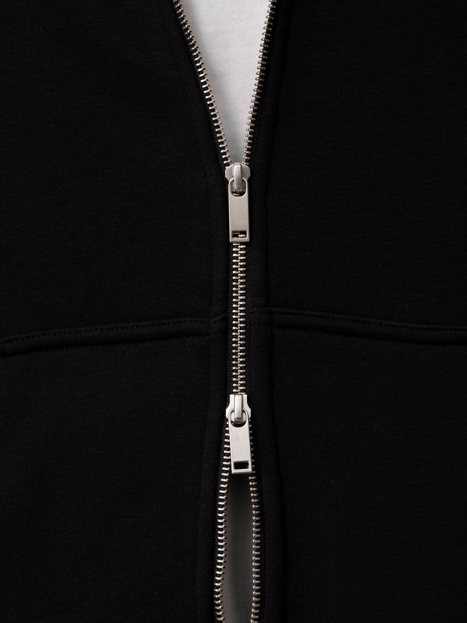 Black Cozy Zip Up hoodie by Sweats UK, featuring a comfortable fit and front zipper, shown on a model.