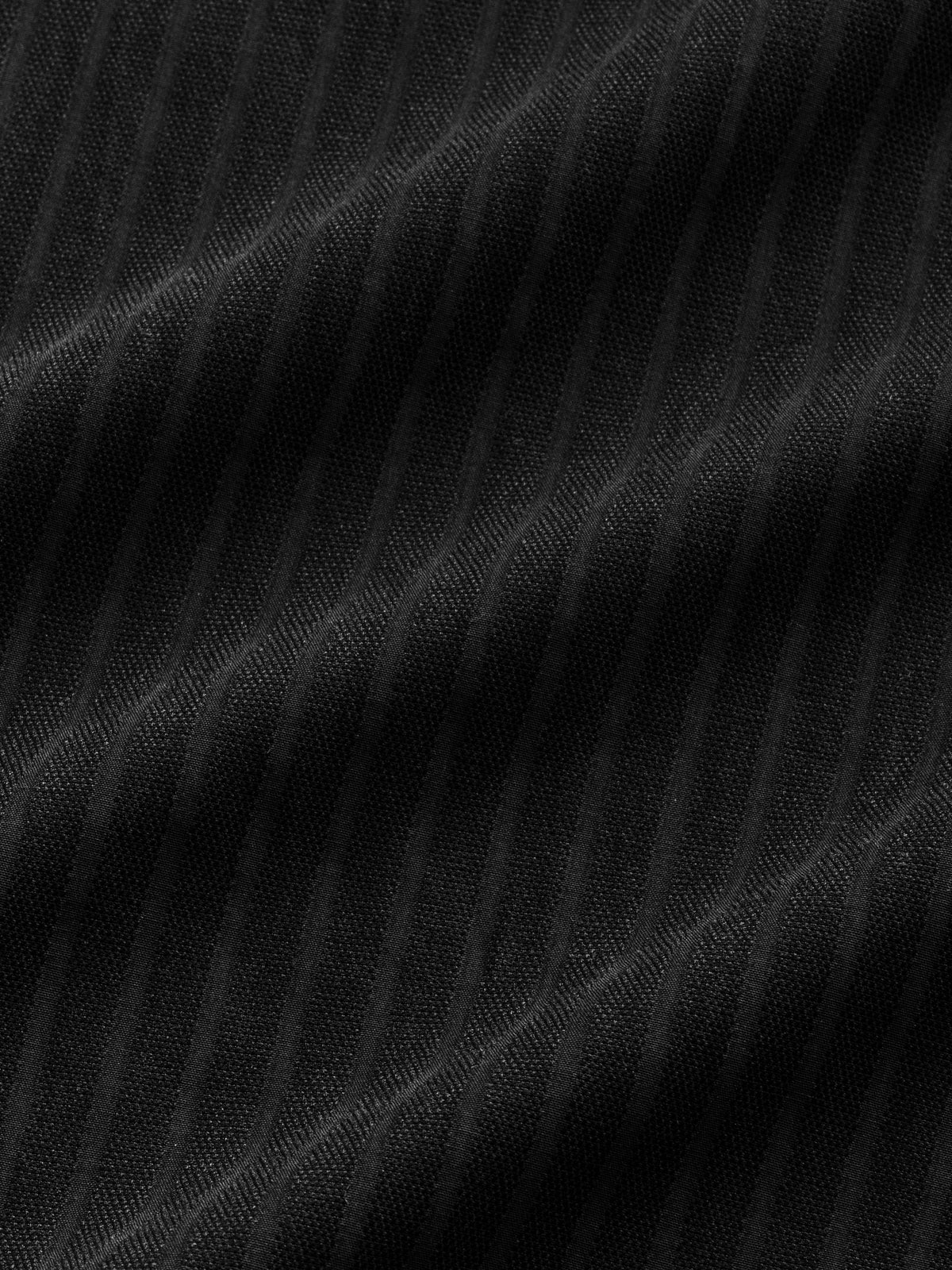 Black striped button-up shirt from Sweats UK displayed flat, showing the collar, buttons, and striped pattern on the fabric.