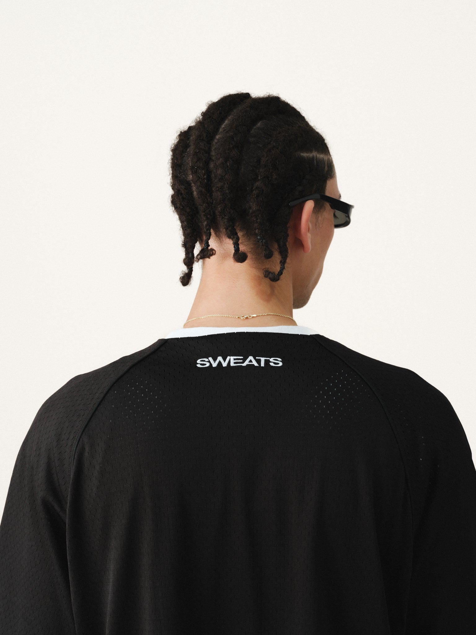 Black baseball jersey by Sweats UK with team logo and button-up front, displayed on a plain background.