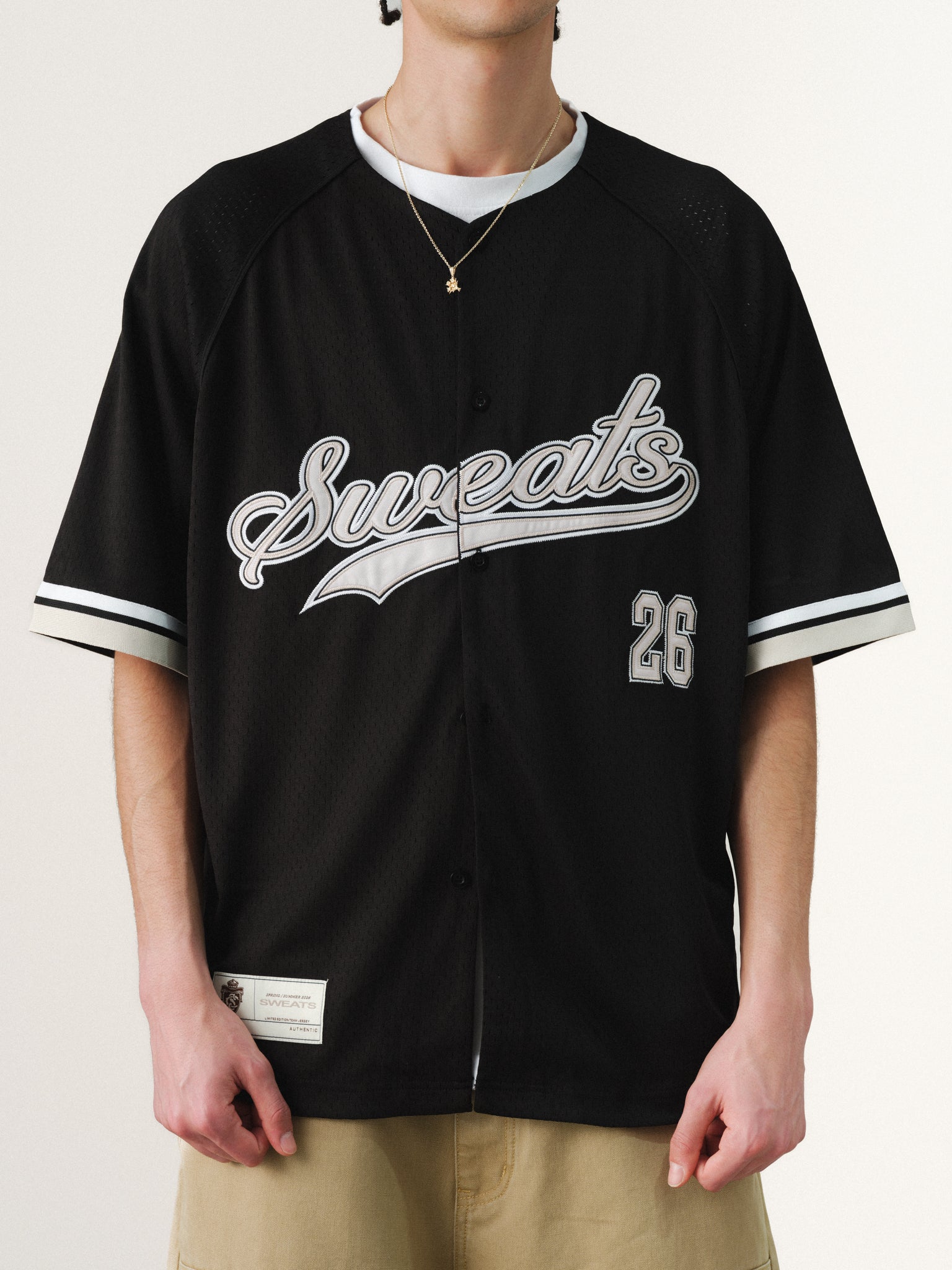 Black baseball jersey by Sweats UK, featuring classic design and team-style lettering, laid flat on a neutral background.