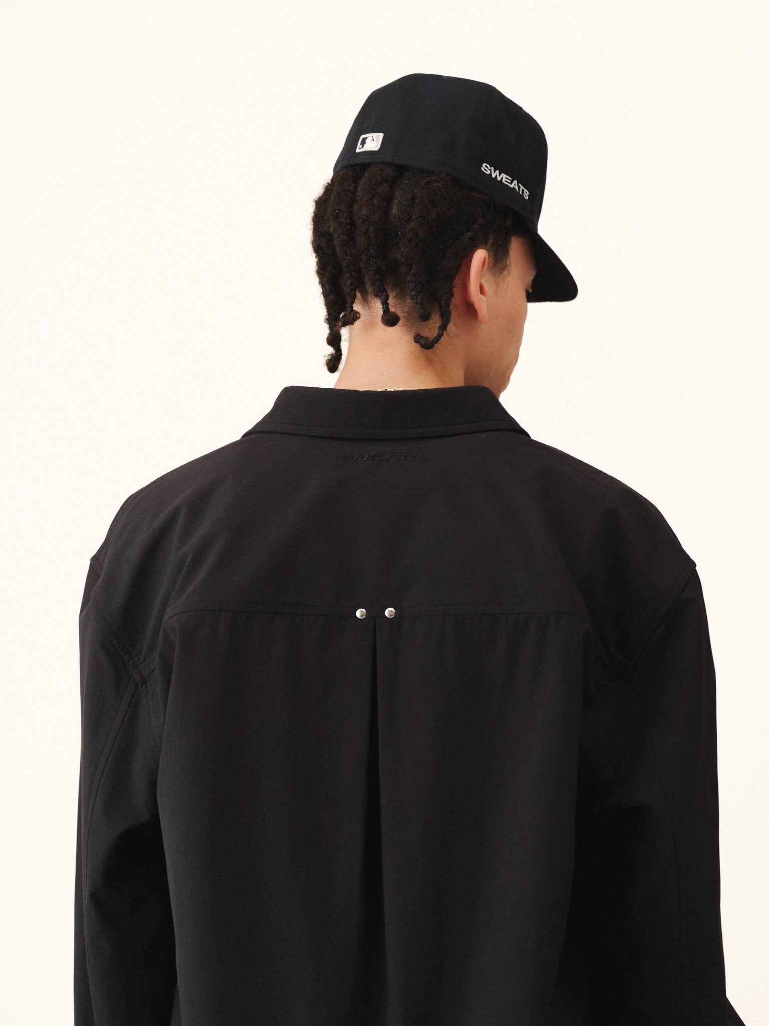 Black Signature Button Up shirt by Sweats UK, featuring a classic collar and button front, displayed on a hanger.