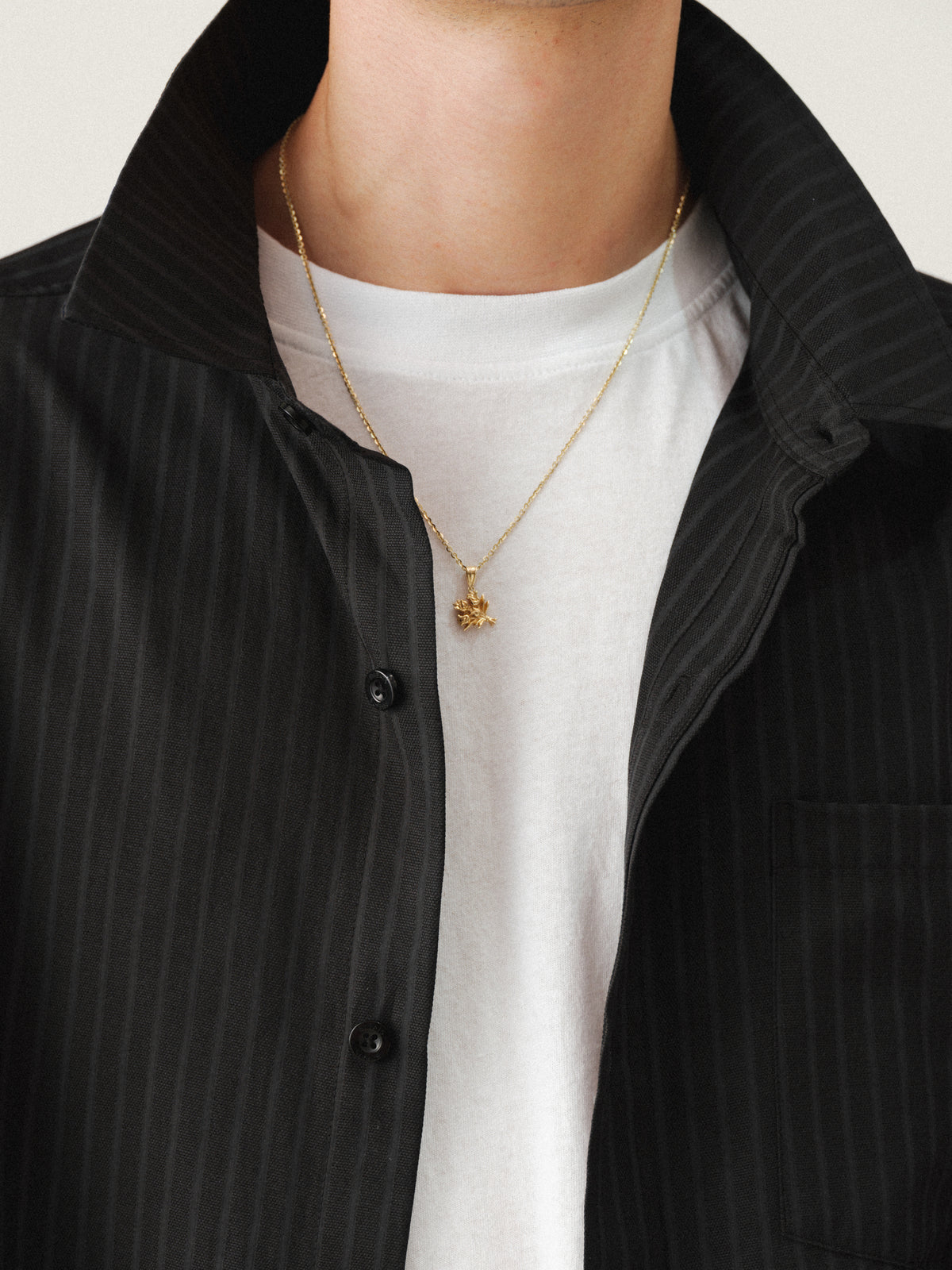 Black striped button-up shirt by Sweats UK, featuring a classic collar and long sleeves, displayed on a neutral background.