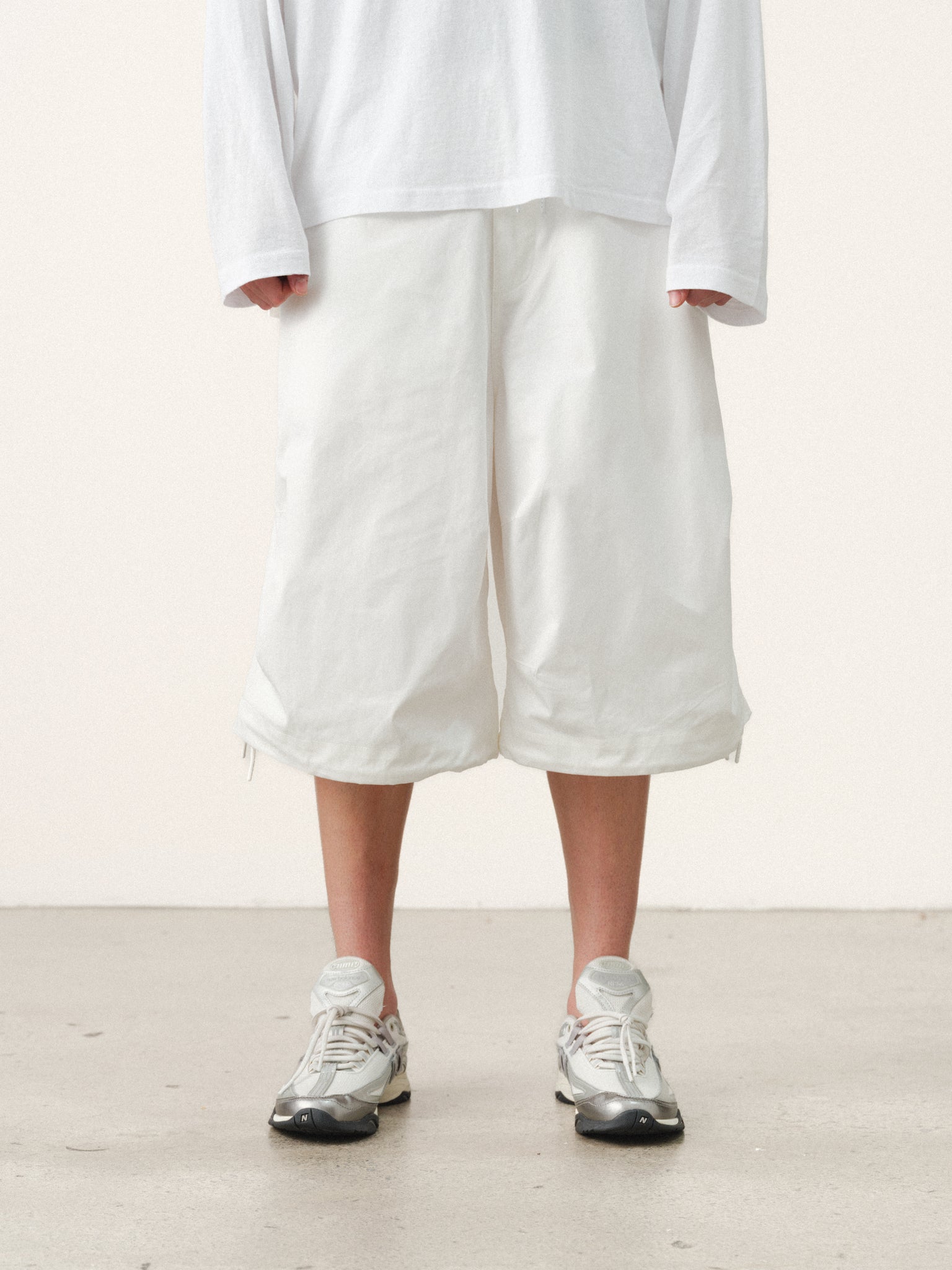 White V3 Flight Shorts by Sweats UK displayed on a model, featuring a relaxed fit and sporty design.