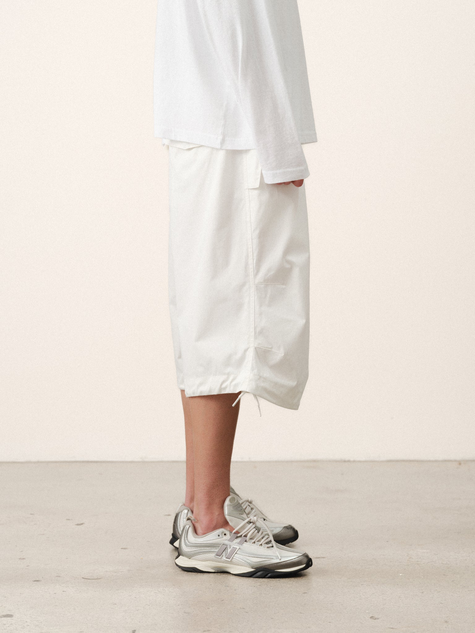 White V3 Flight Shorts by Sweats UK shown on a model, featuring a relaxed fit and casual style for summer wear.