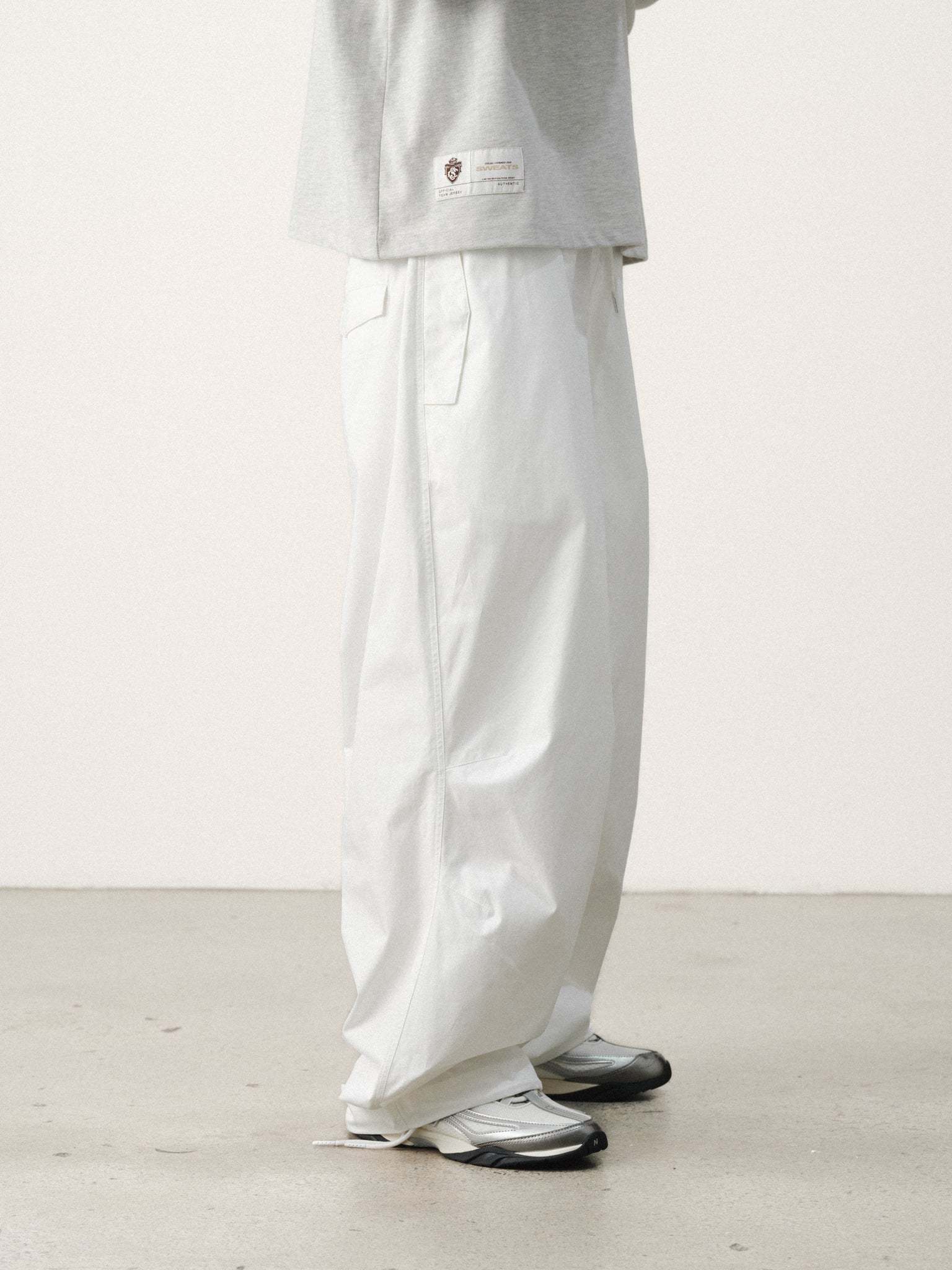 White V3 Flight Pant by Sweats UK, showing a relaxed fit with adjustable waistband and stylish design on a model.