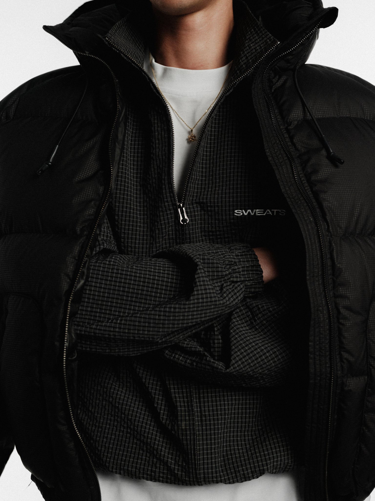 Black and white checkered track jacket by Sweats UK, featuring a stylish sportswear design and zip-up front.