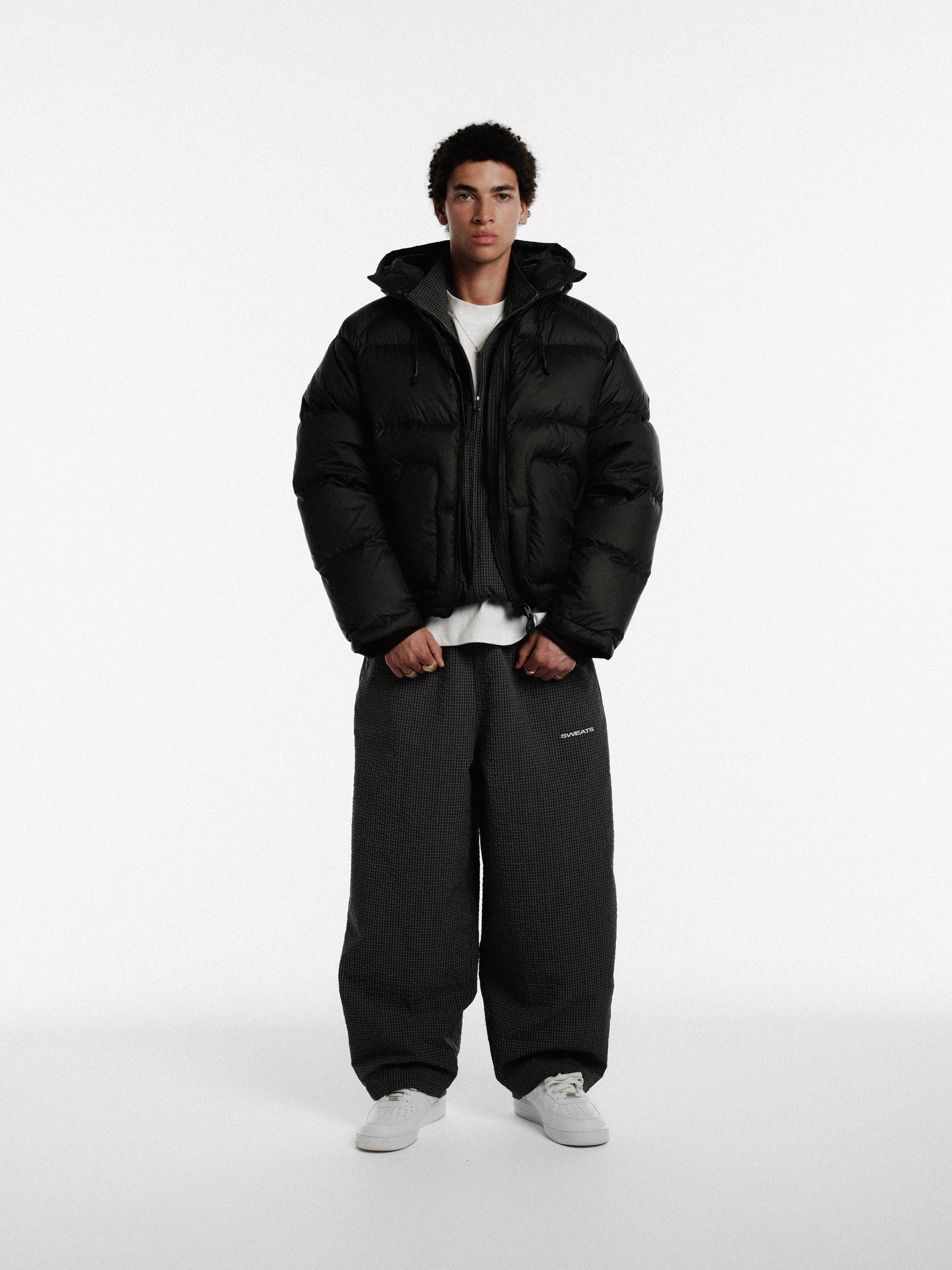 Black and white checkered track pants from Sweats UK with a relaxed fit and elastic waistband.
