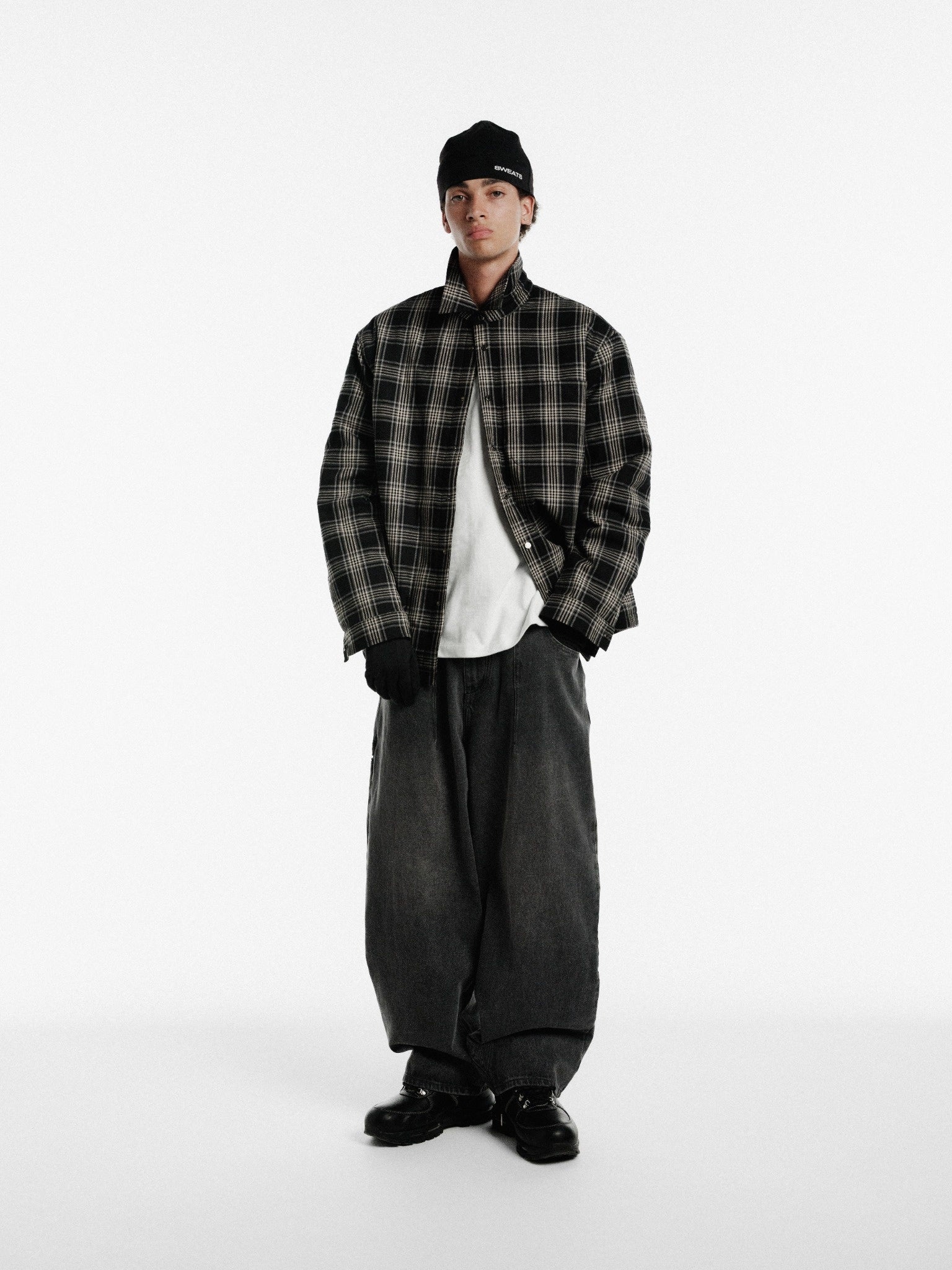 Black flannel jacket by Sweats UK featuring a relaxed fit and button-up front, styled with casual sleeves and a cozy look.
