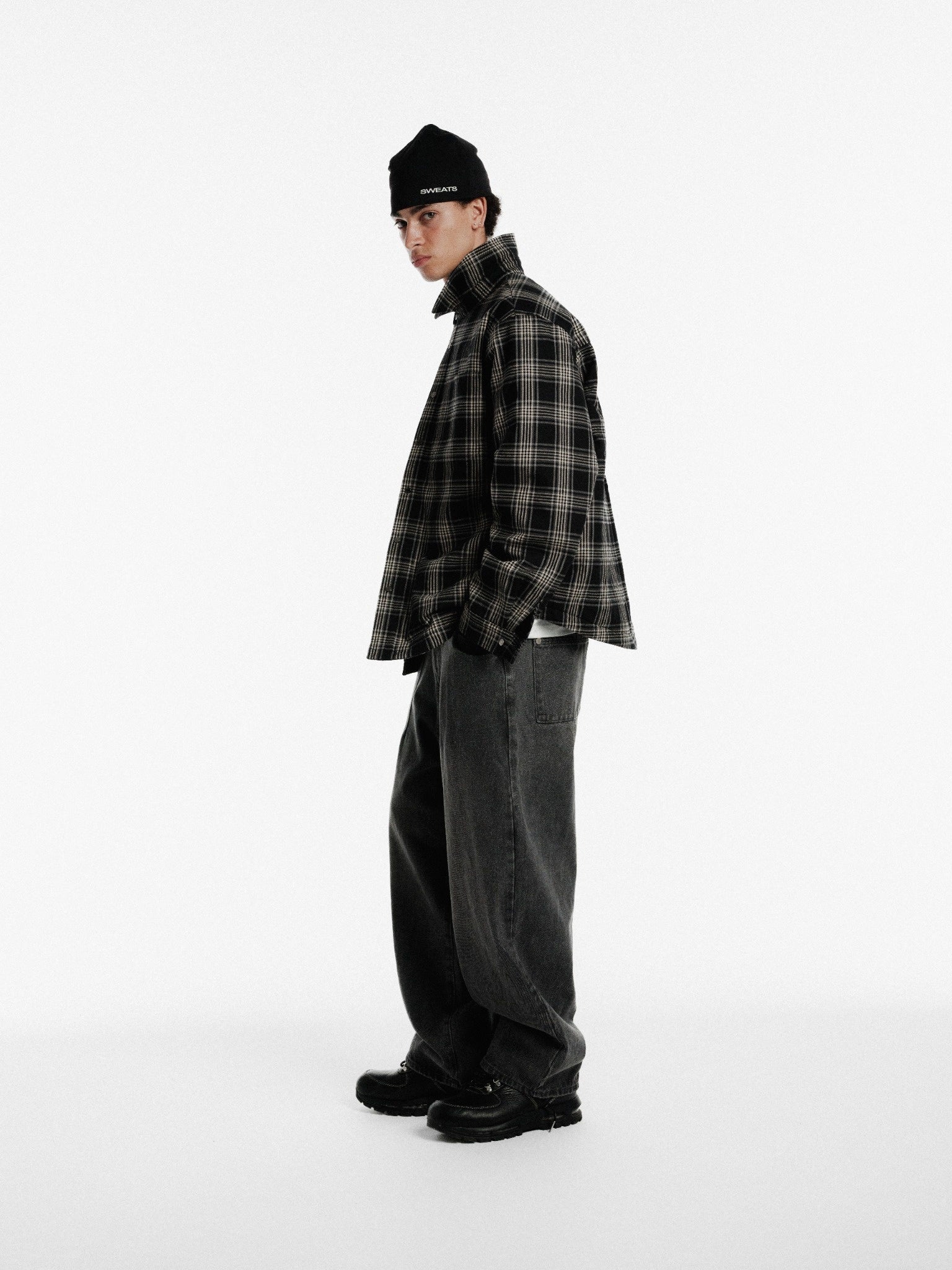 Black flannel jacket by Sweats UK, shown on a hanger with a soft, cozy fabric and classic button front design.