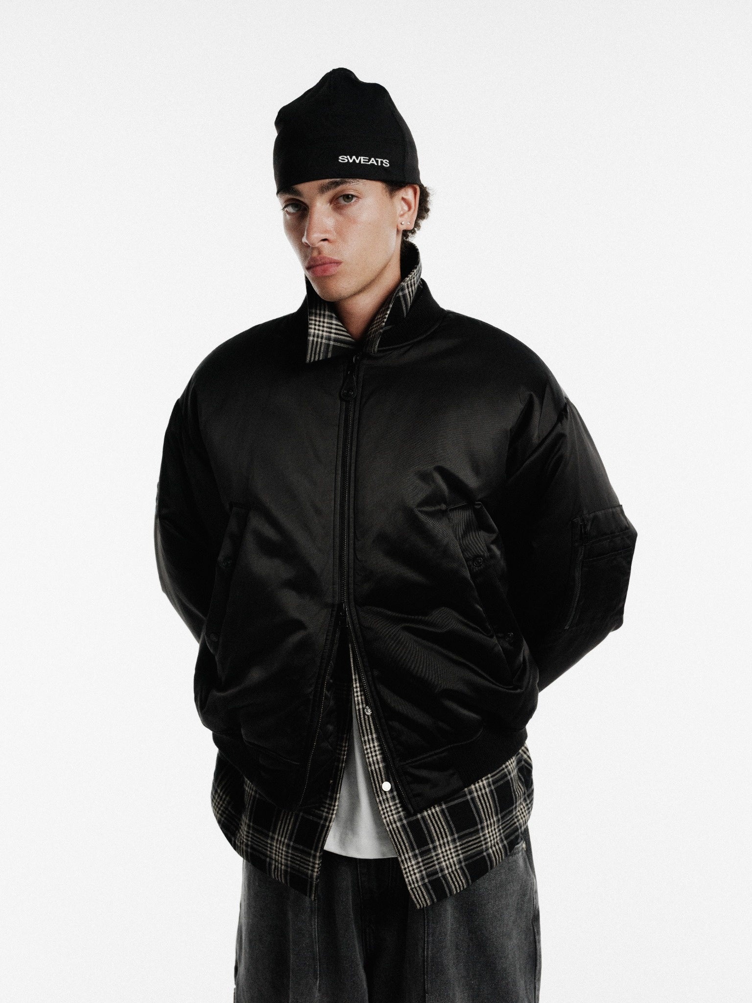 Black bomber jacket from Sweats UK featuring a fitted design and stylish collar, ideal for casual winter wear.