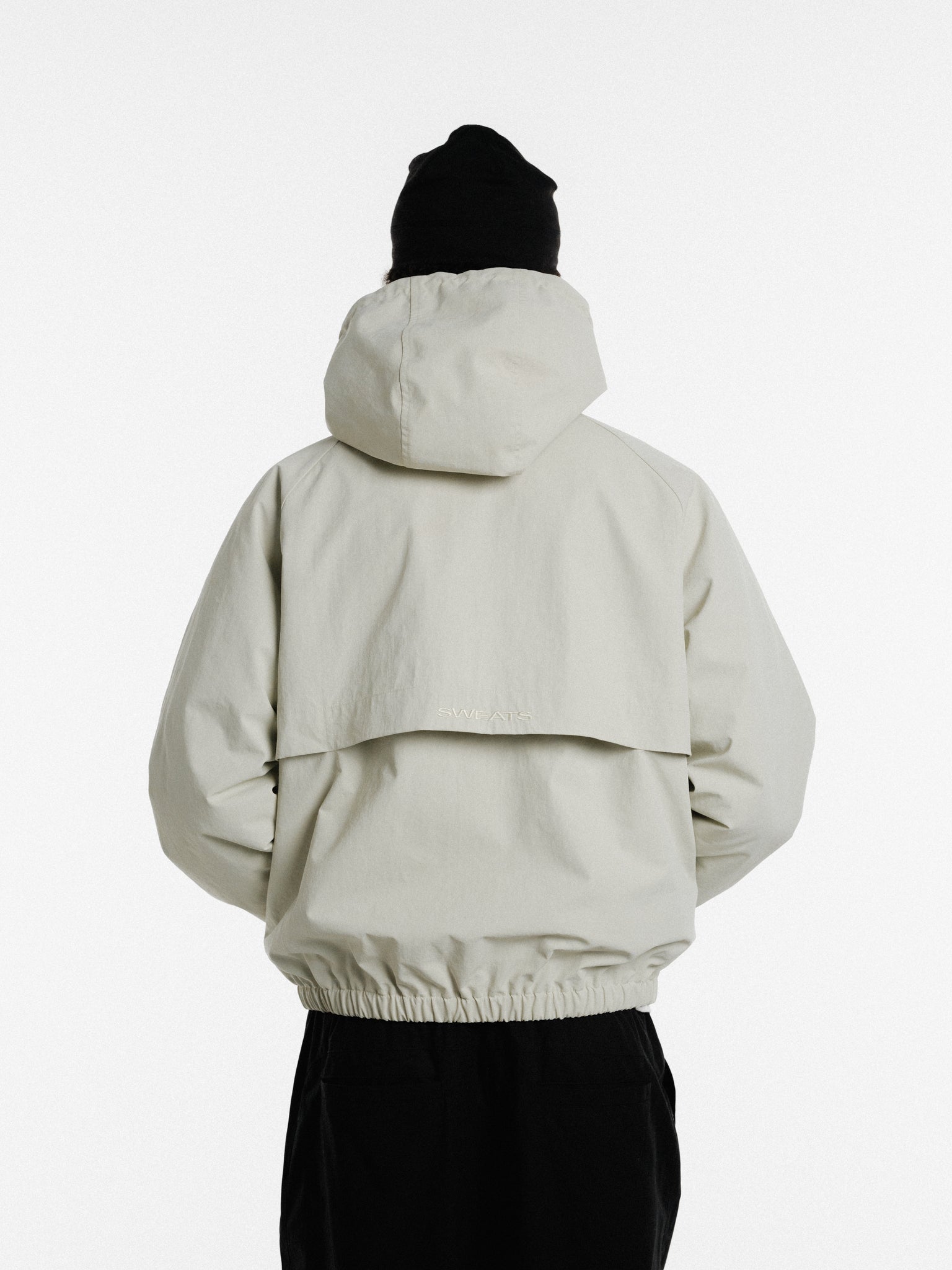 Sweats UK ARC Jacket in stone color displayed, featuring a stylish winter jacket with a zip front and adjustable collar.