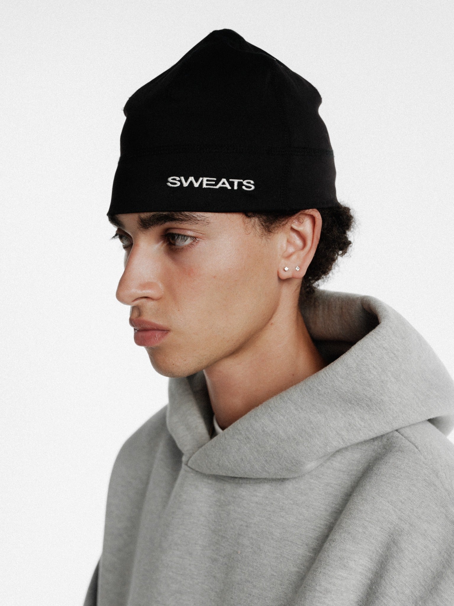 Black SPORTSKULLY beanie hat by Sweats UK, showing a snug fit and soft knit fabric for winter warmth.