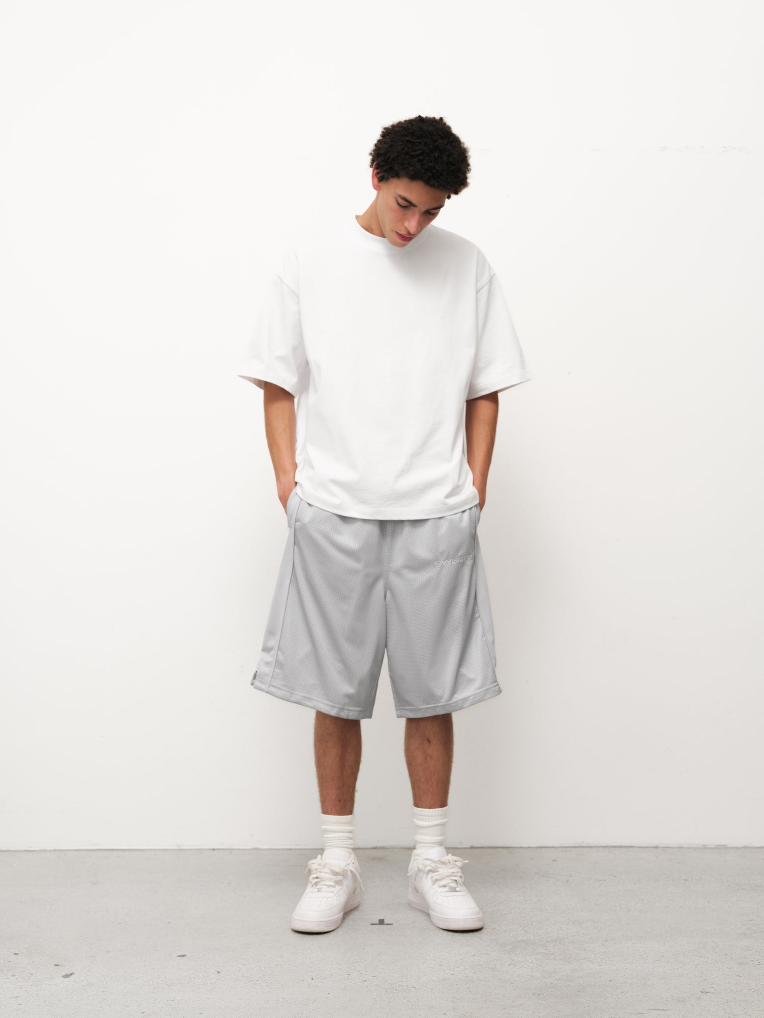 Gray mesh shorts from Sweats UK, featuring a lightweight fabric and sporty design, perfect for active wear or casual outings.