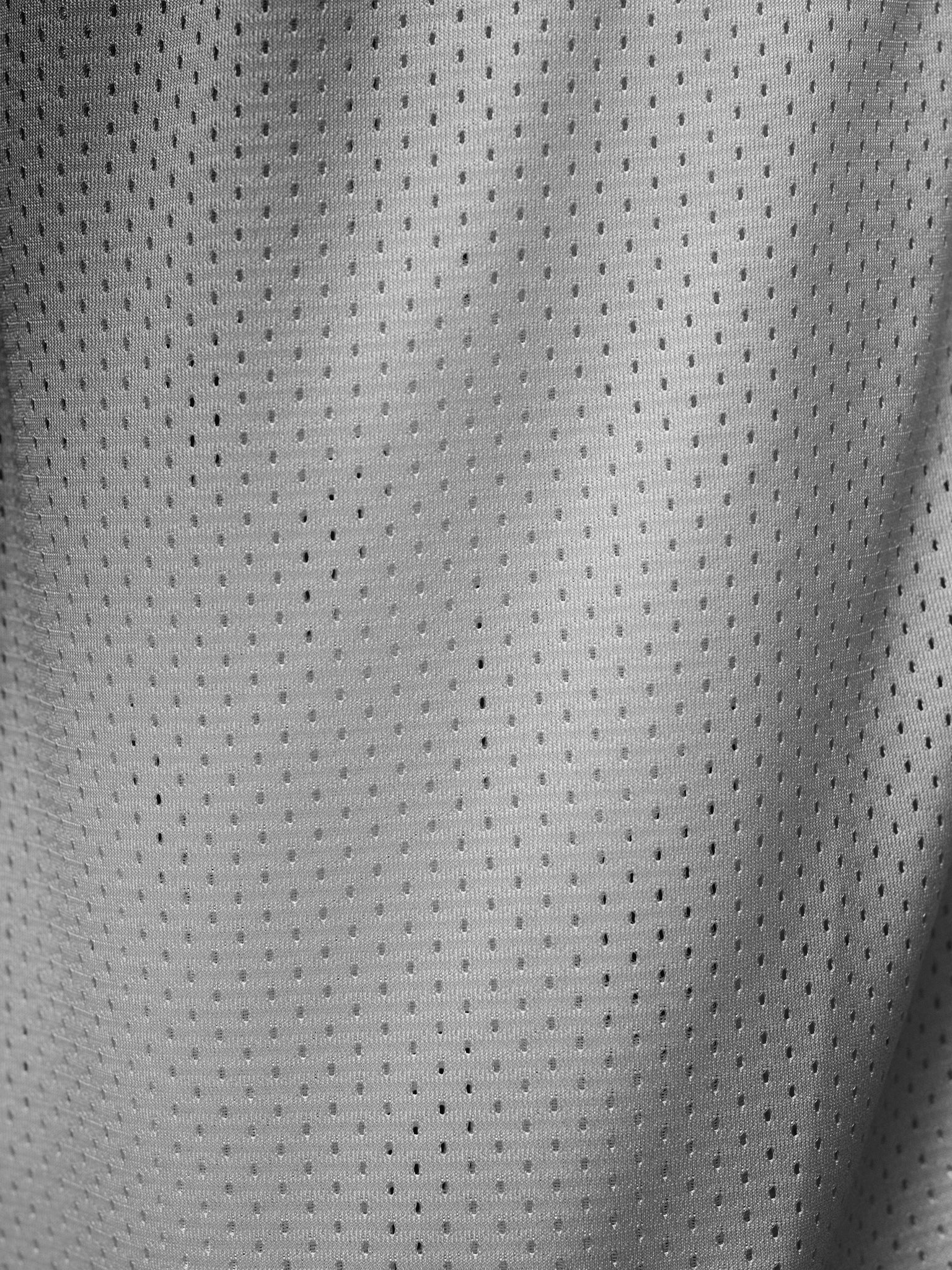 Grey mesh shorts by Sweats UK, featuring a lightweight breathable design and athletic fit for casual or active wear.