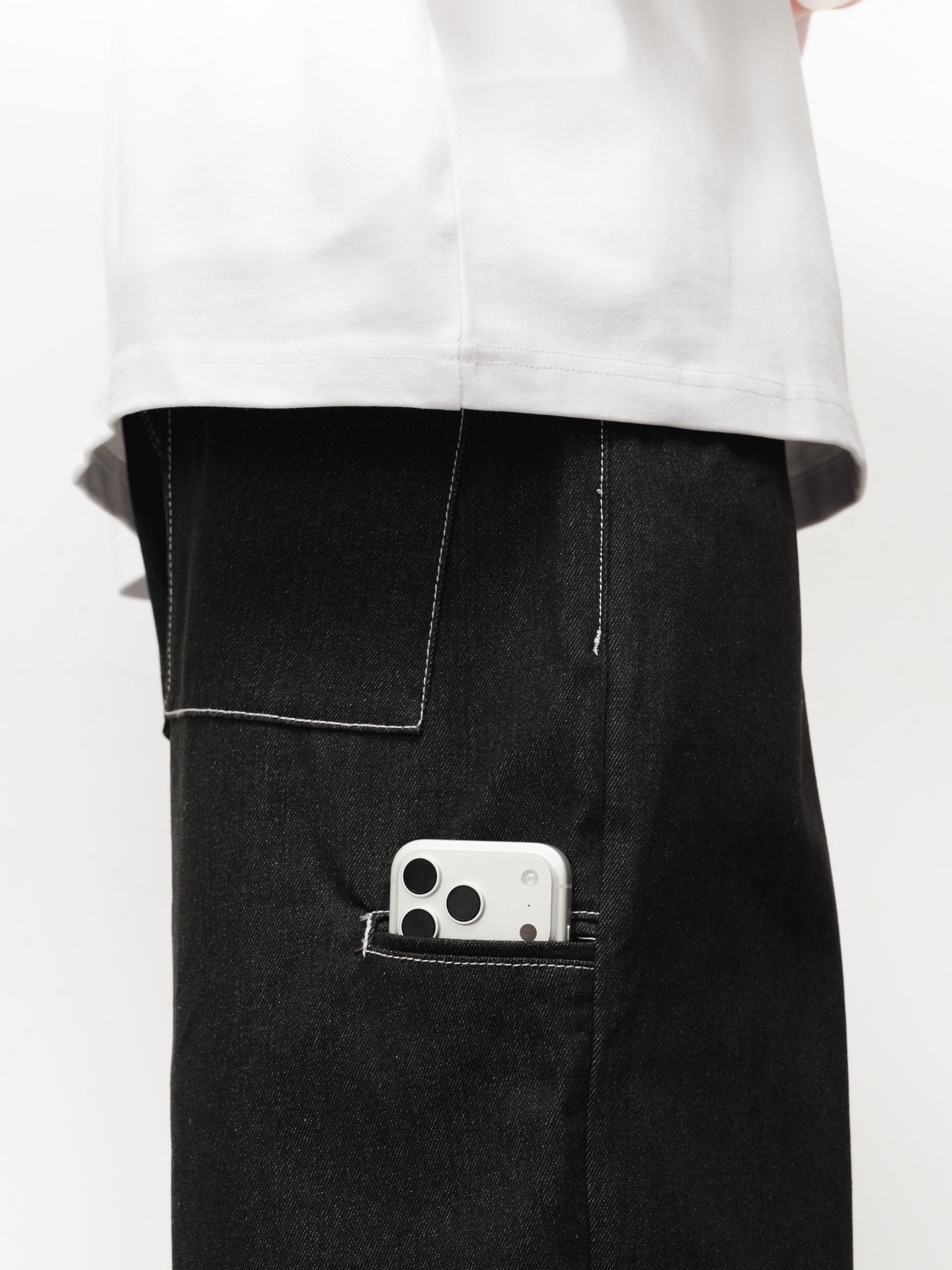 Black denim baggy jeans by Sweats UK, shown on a model with a relaxed fit and casual style.