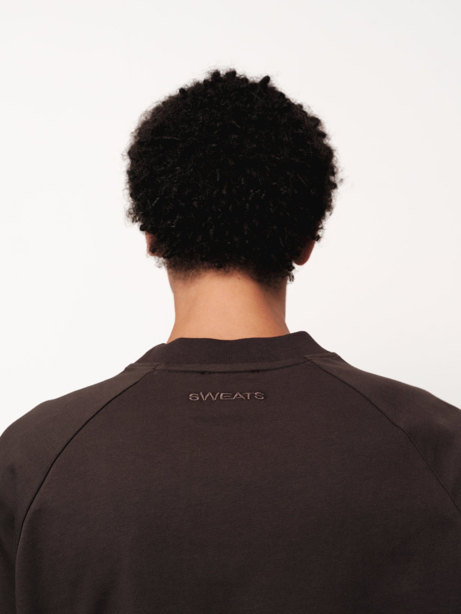 Long sleeve coffee-colored T-shirt by Sweats UK displayed on a model, showcasing comfortable casual clothing.