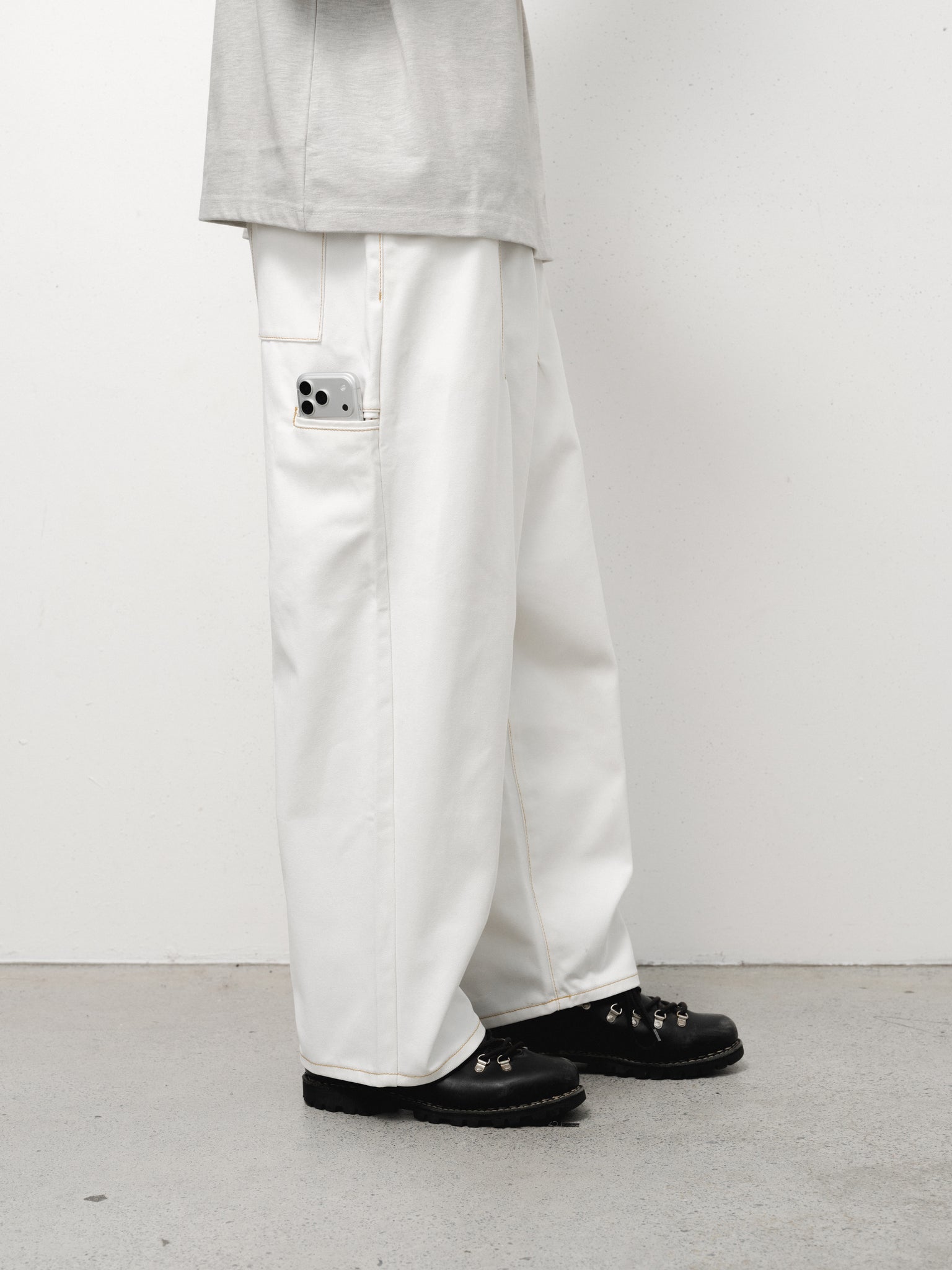 White denim baggy jeans from Sweats UK, showing relaxed fit and classic five-pocket design on a full-stock image.