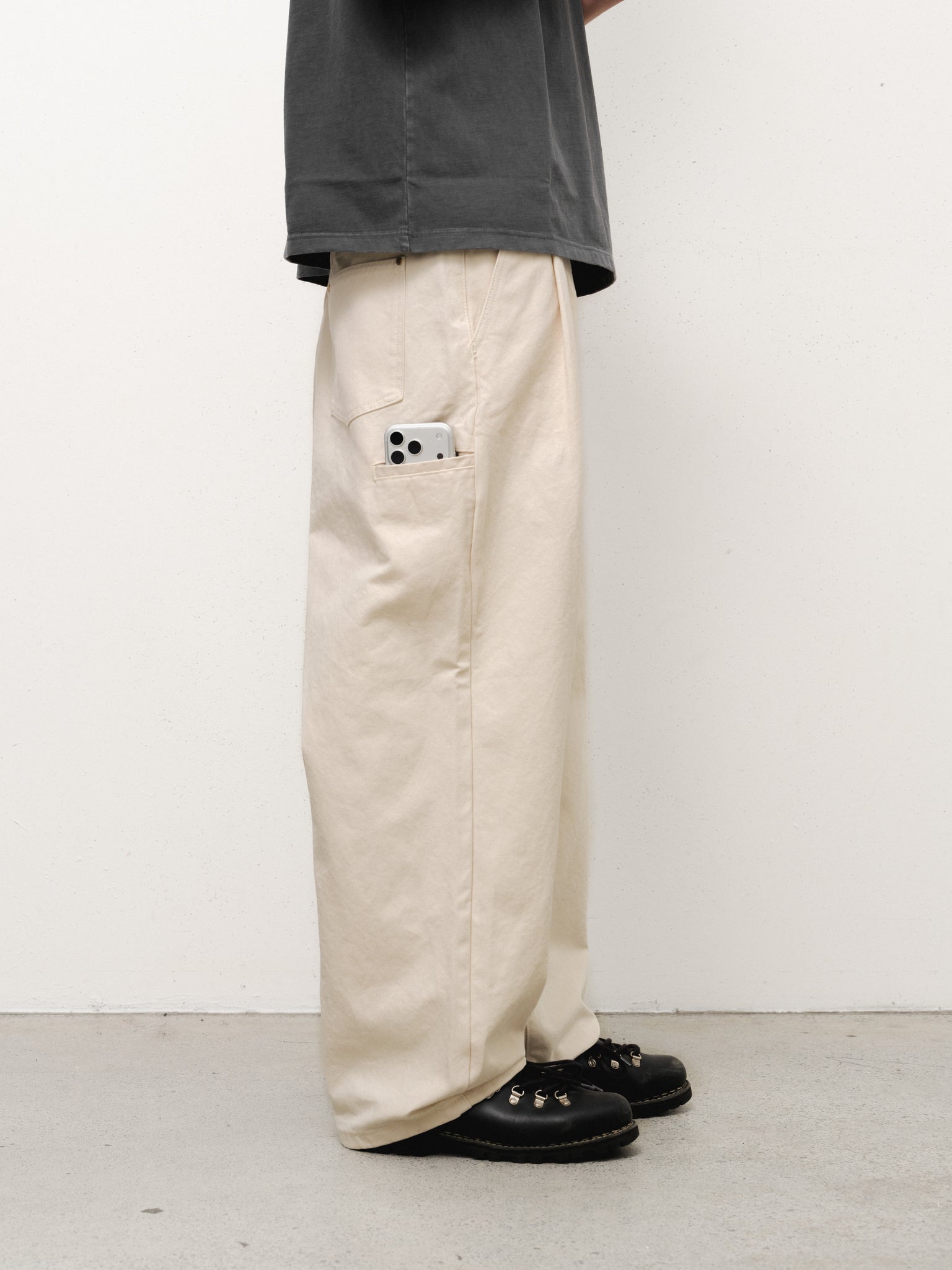Ecru workwear pants by Sweats UK, full-length with a relaxed fit, shown on a model against a neutral background.