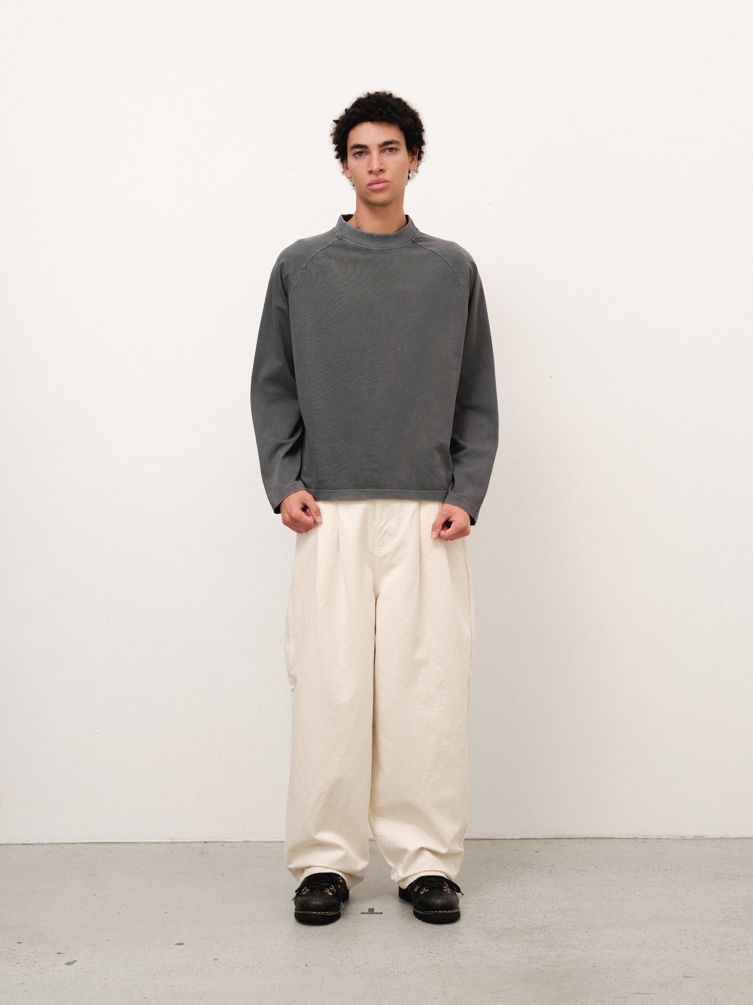 Washed grey long sleeve T-shirt by Sweats UK displayed on a model, showcasing casual style and comfortable fit.