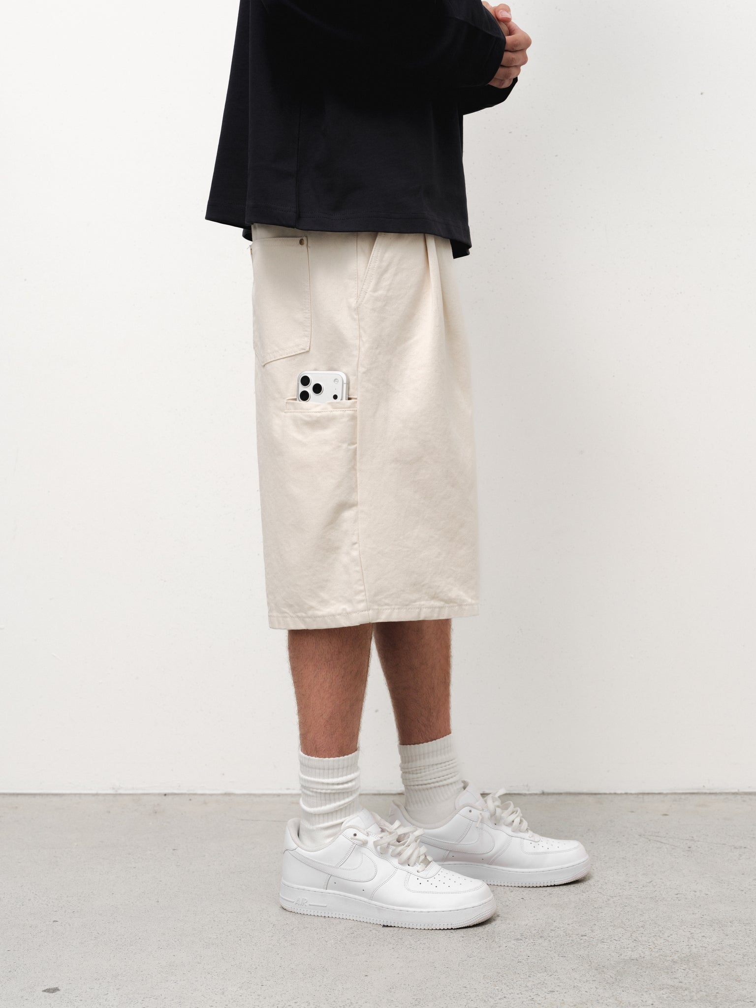 Ecru workwear shorts by Sweats UK, featuring durable fabric and a comfortable fit, displayed on a model.