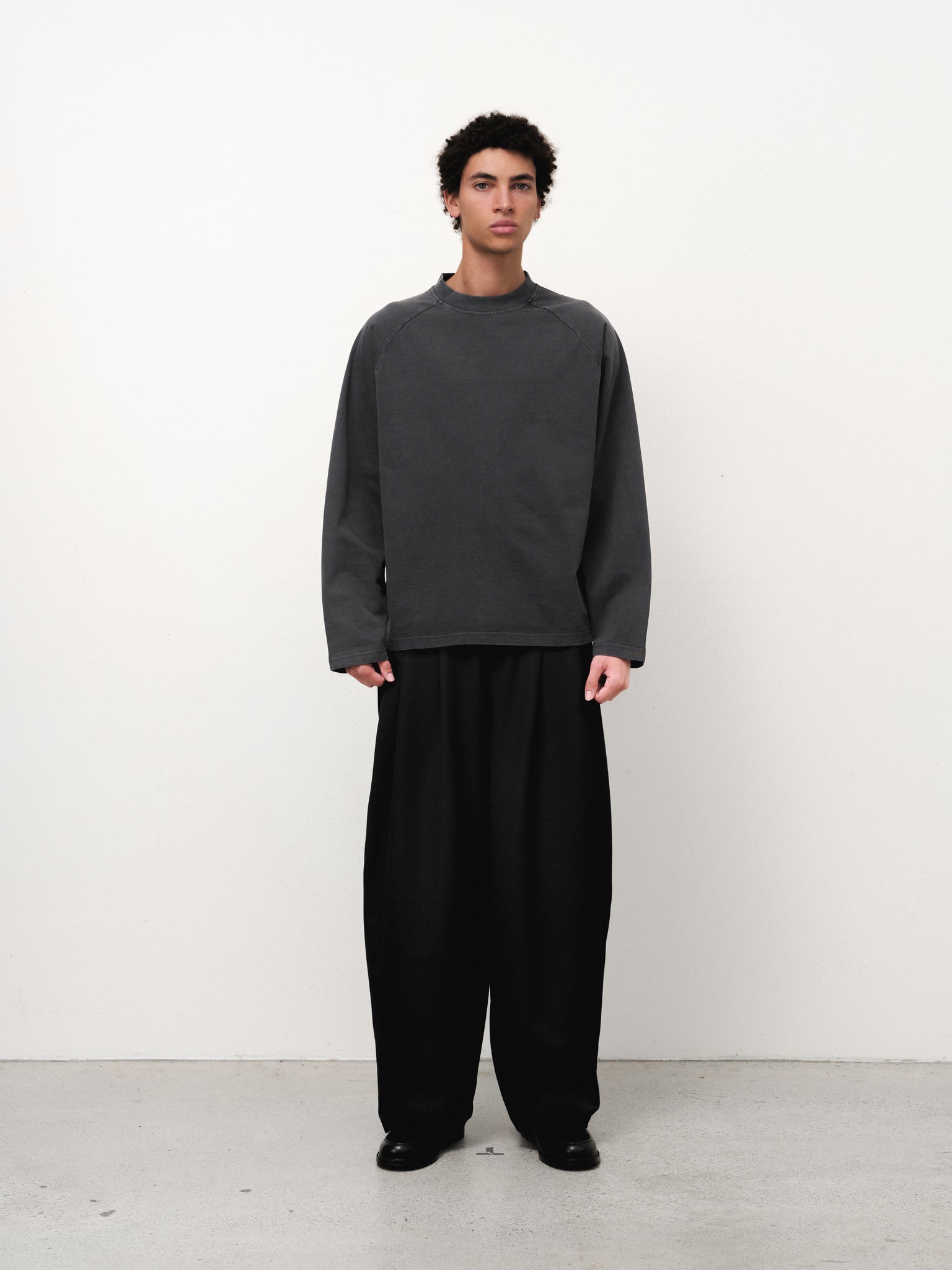 Sweats UK long sleeve T-shirt in washed black, shown on model with casual fit and soft fabric texture.