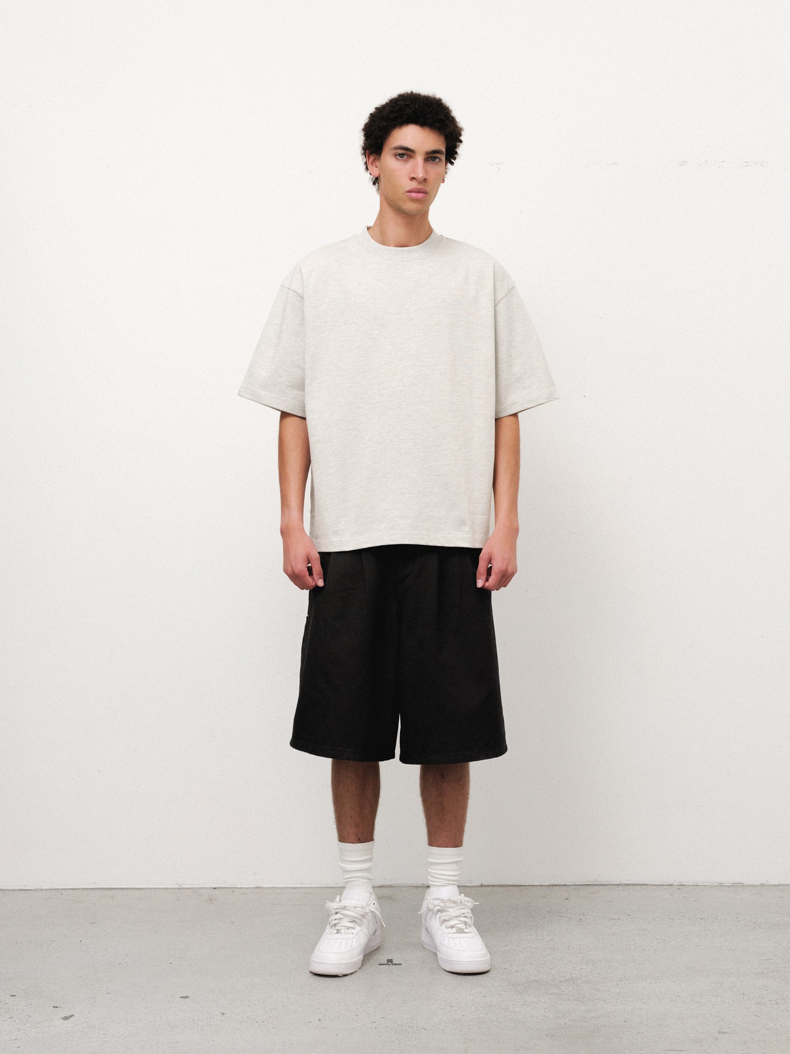 Arctyc SIGNATURE BLANK T-shirt by Sweats UK displayed on a hanger, showcasing the simple, classic design in a neutral color.