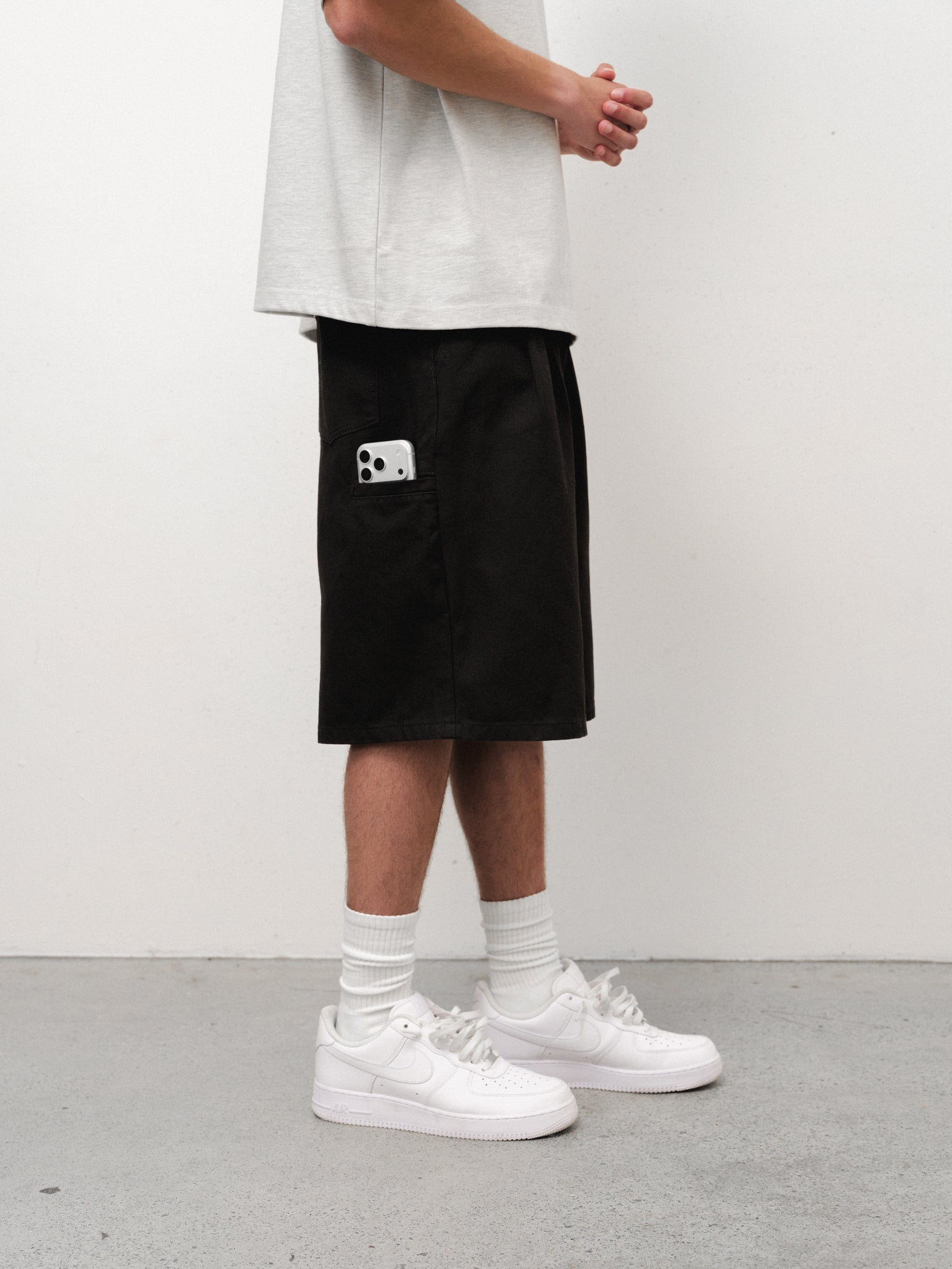 Black workwear shorts by Sweats UK, featuring durable fabric and practical design for industrial or casual wear.