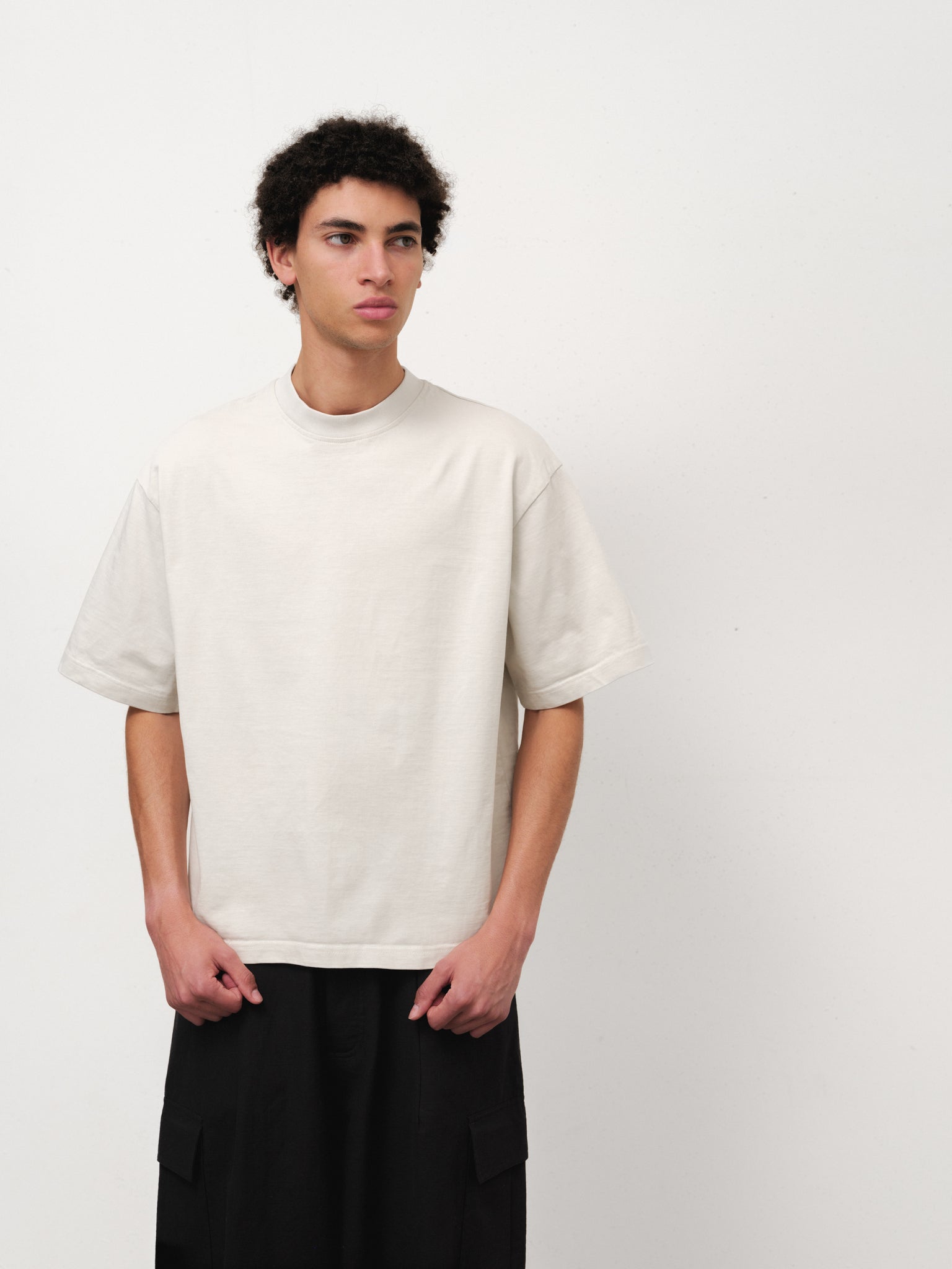 White SIGNATURE BLANK T-shirt by Sweats UK laid flat, showing the plain chalk-colored cotton fabric and simple crew neck design.