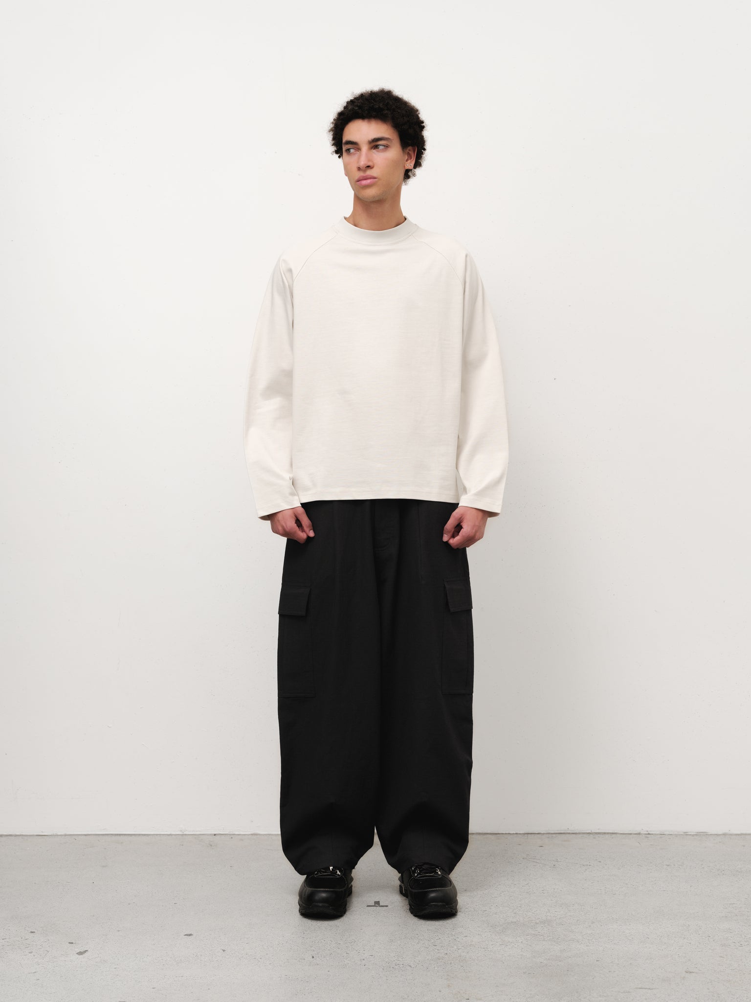 Long sleeve T-shirt in chalk color by Sweats UK, shown flat with front view, soft fabric and casual fit.