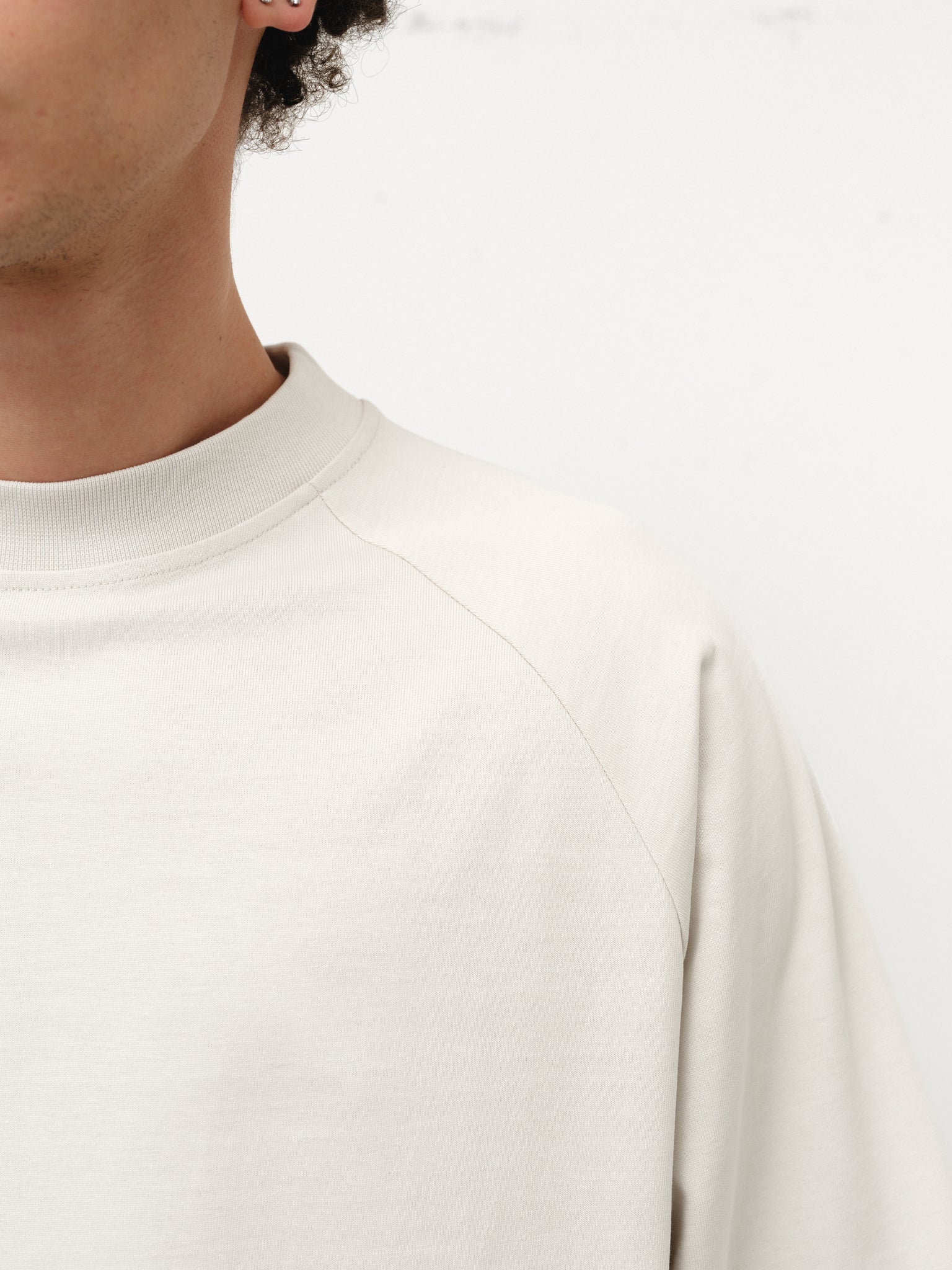 Long sleeve chalk T-shirt by Sweats UK, shown on model, with a casual fit and simple design.