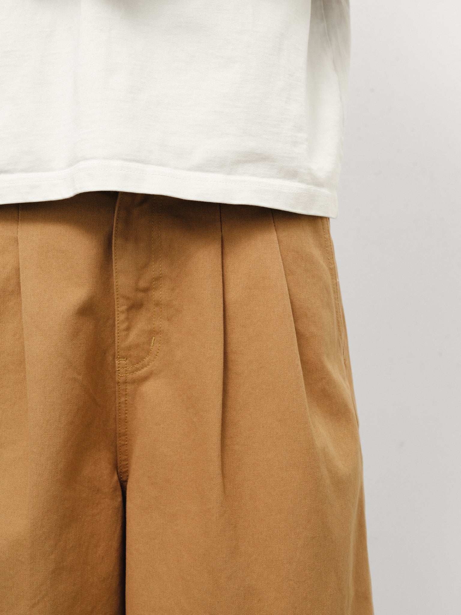 Tan workwear shorts by Sweats UK, featuring durable fabric and functional design, shown on a model in a professional setting.