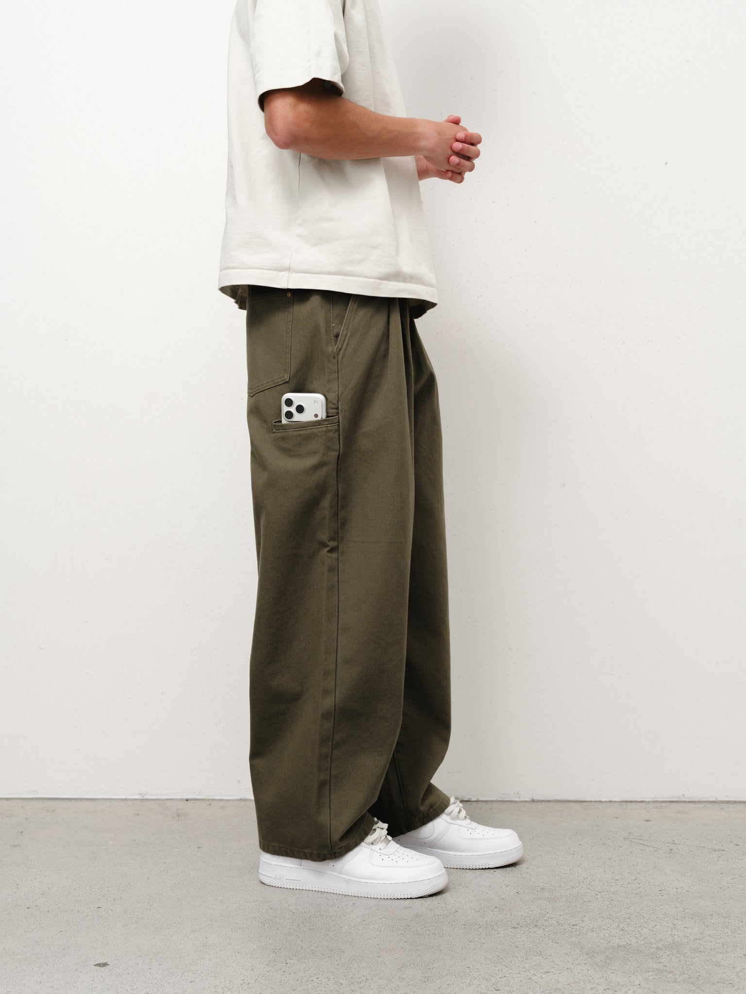 Olive workwear pants by Sweats UK, featuring durable fabric and practical design for industrial or outdoor work environments.