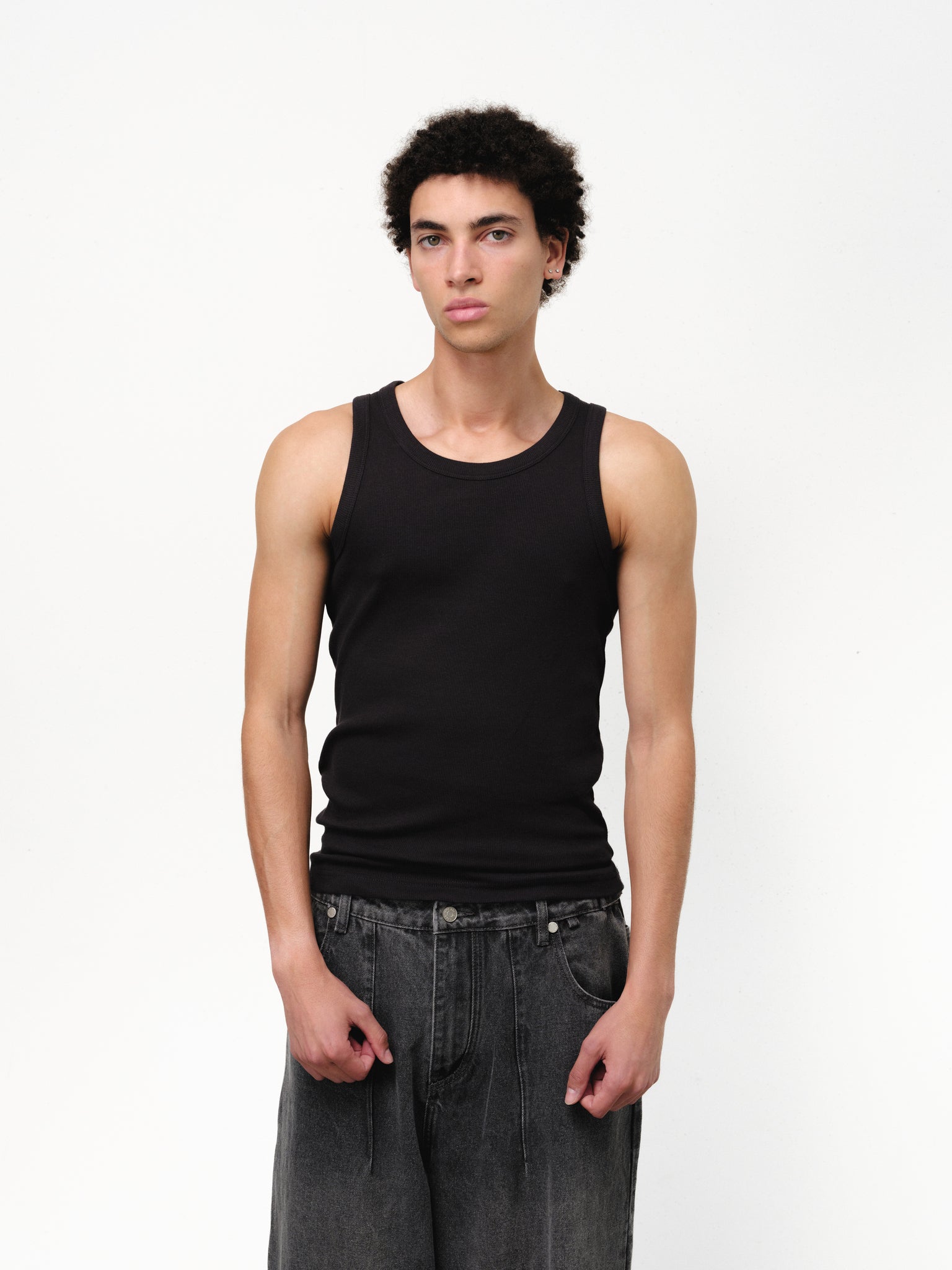 Black tank singlet from Sweats UK, displayed on a mannequin, highlighting its sleeveless design and casual fit.