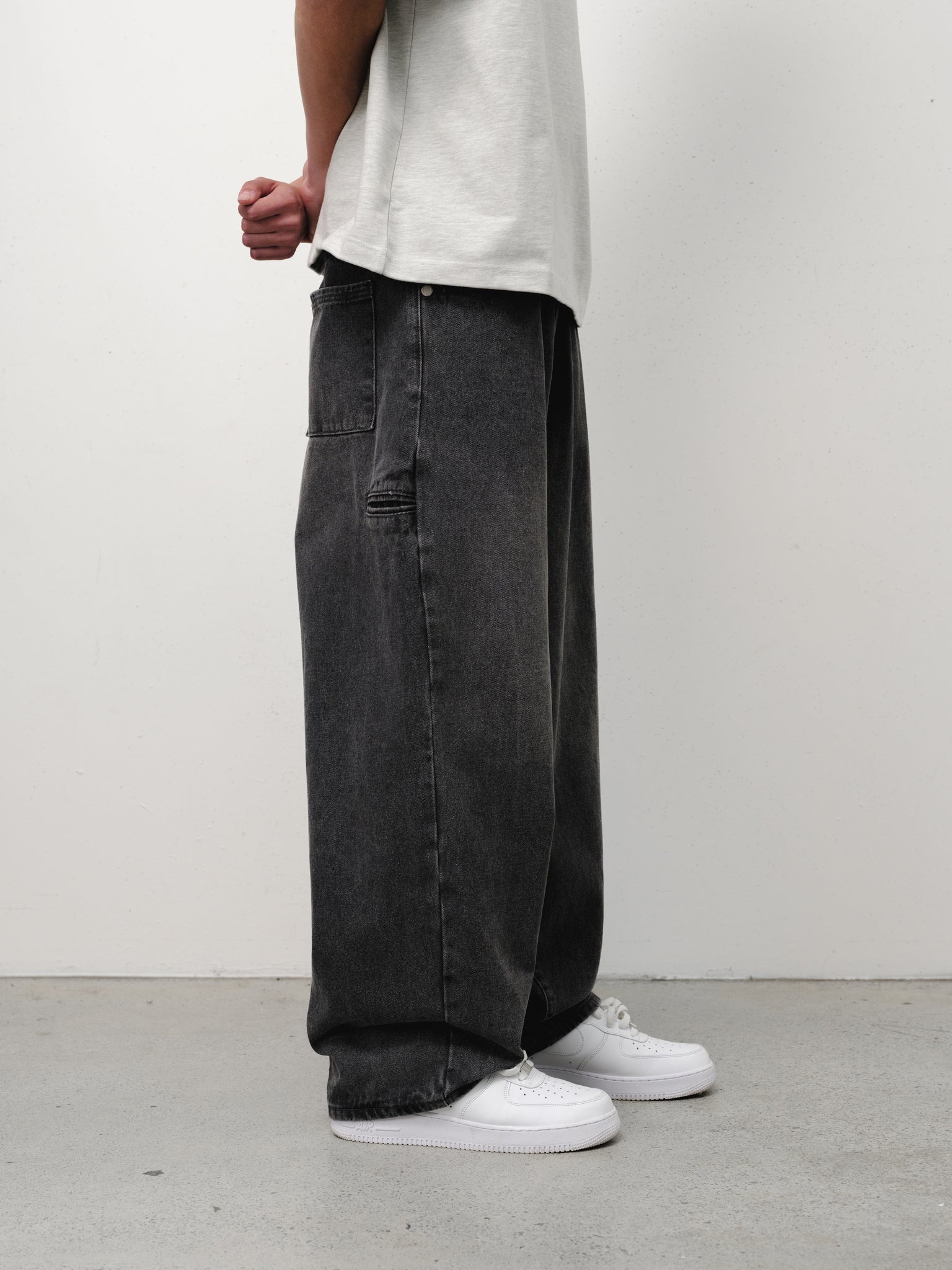 Washed black denim baggy jeans from Sweats UK, showcasing relaxed fit and classic denim texture.