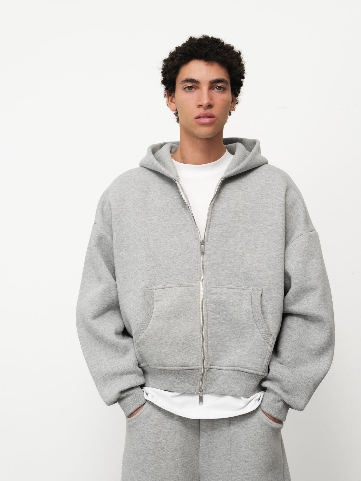 Grey Cozy Zip Up hoodie from Sweats UK, featuring a comfortable fit and front zipper, displayed on a hanger.