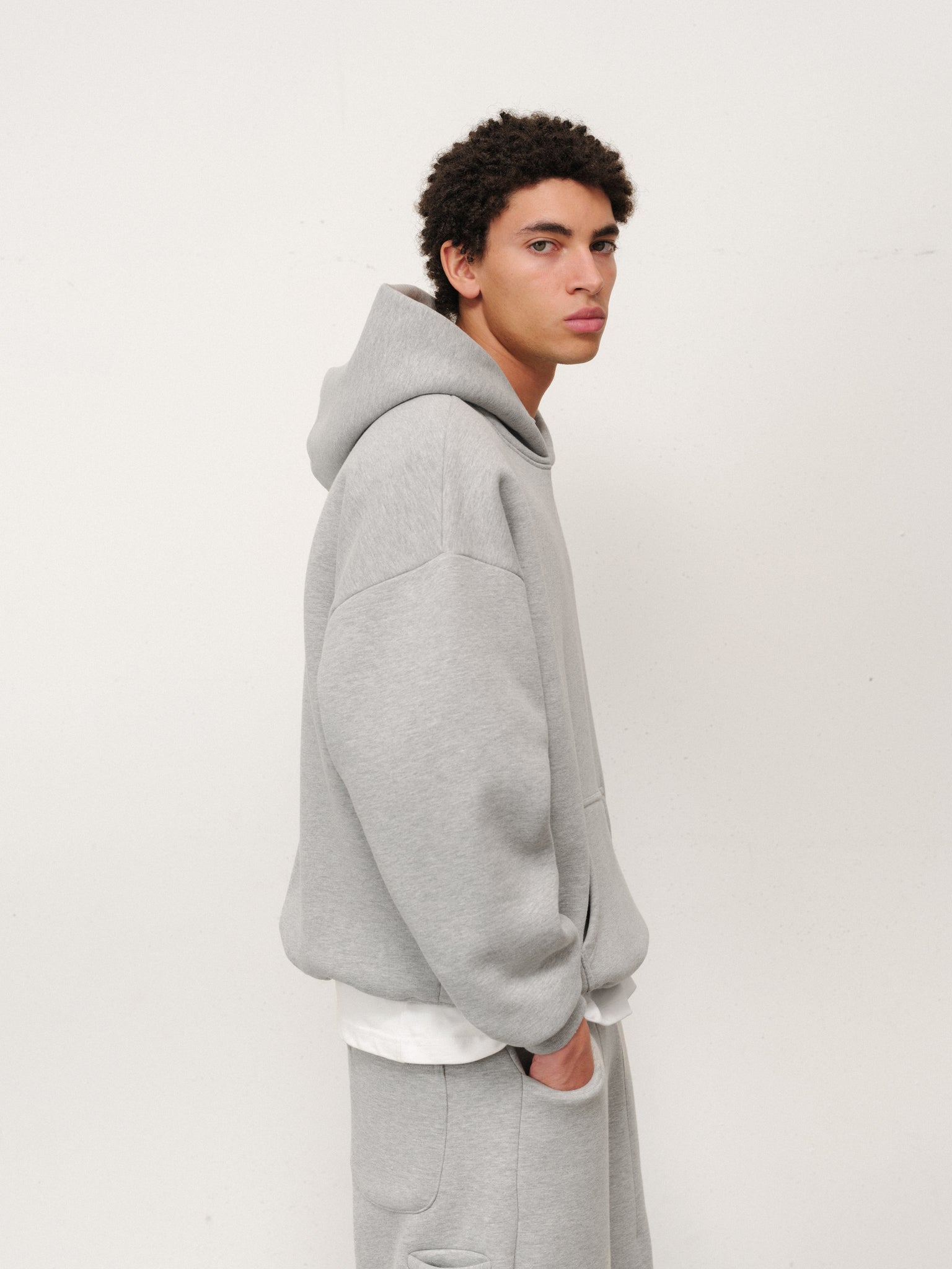 Grey Cozy Hoodie by Sweats UK laid flat, showing soft fabric, drawstrings, and relaxed fit for comfortable casual wear.