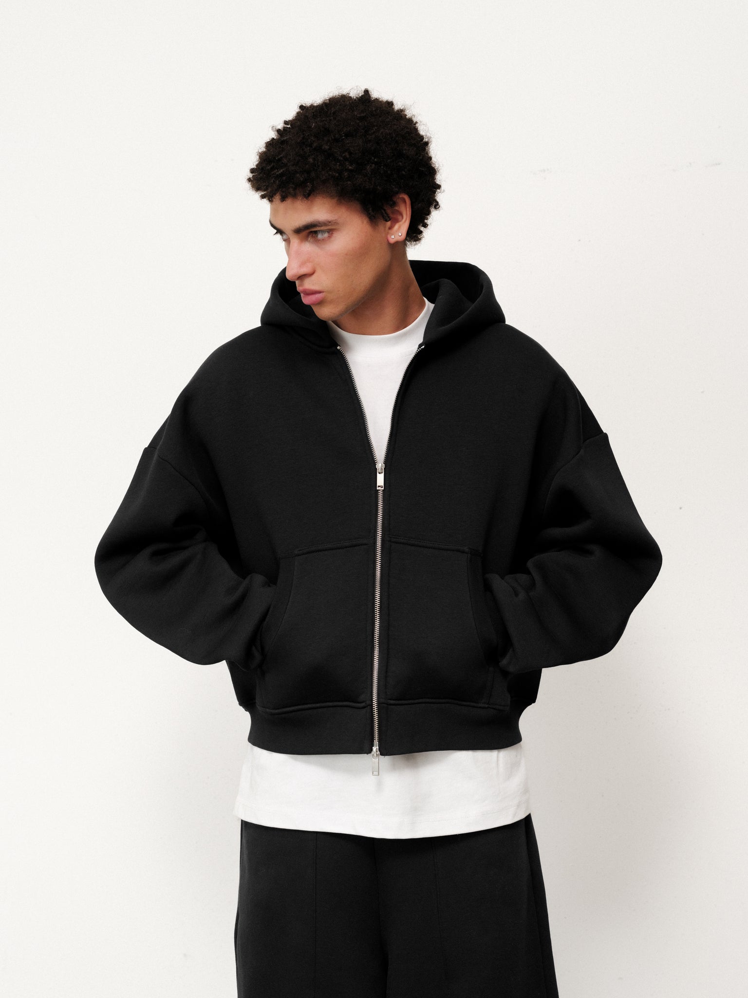 Black Cozy Zip Up hoodie by Sweats UK, showing a close-up of the front zipper and soft fabric texture.