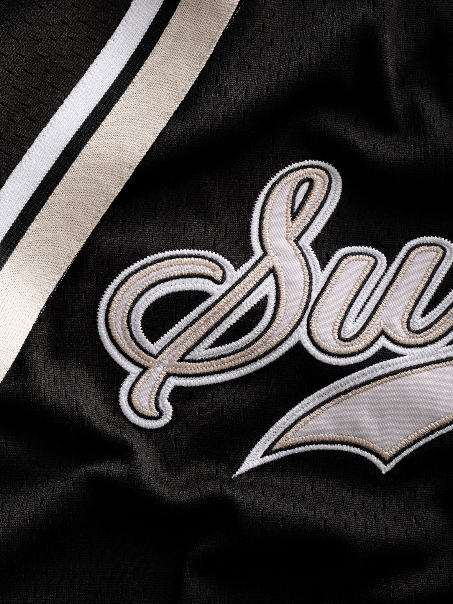 Black baseball jersey from Sweats UK displayed flat, showing front design and classic athletic style.