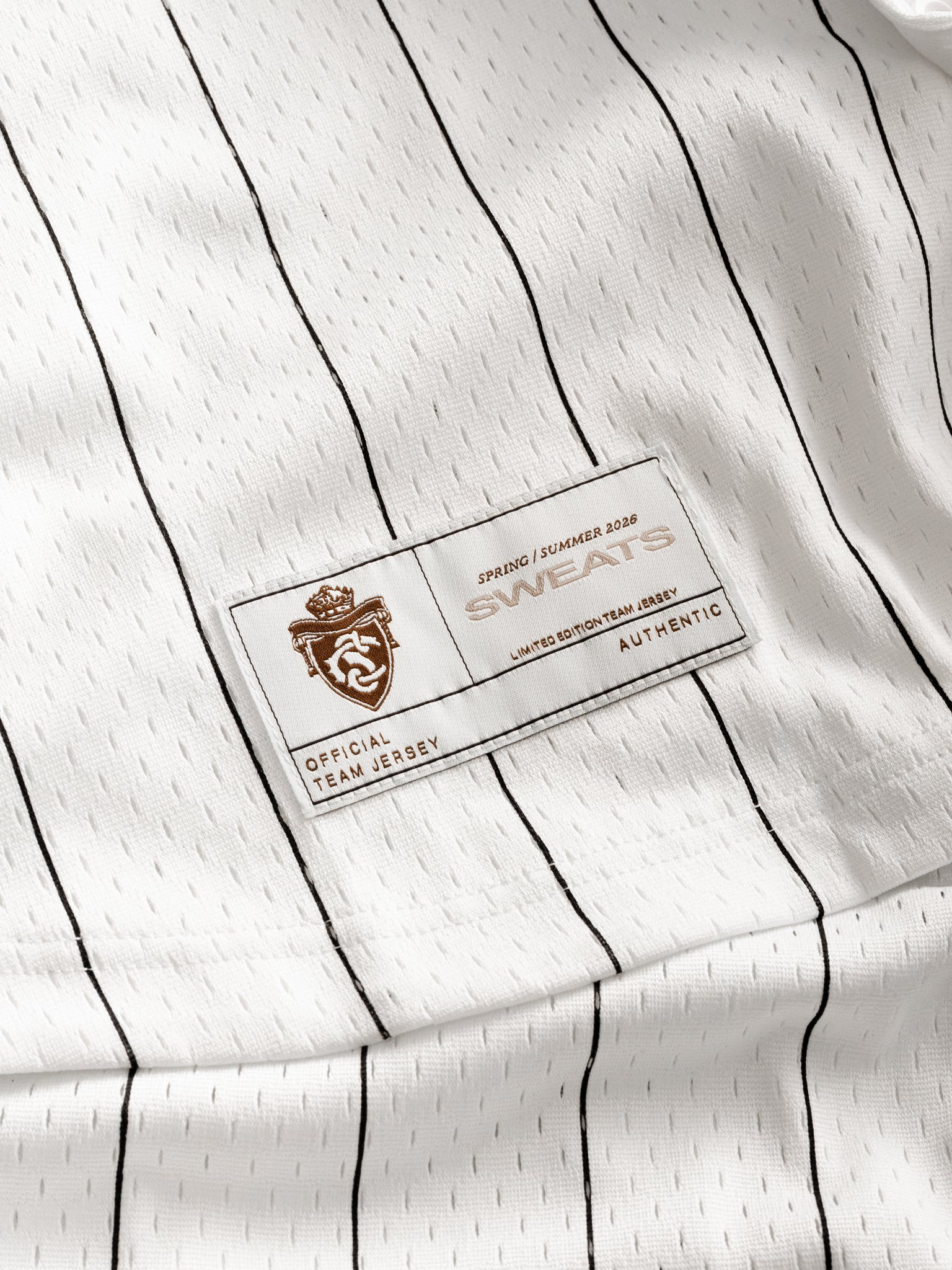 Sweats UK pinstripe baseball jersey laid flat, showing classic white jersey with navy pinstripes, button-up front, and team-style design.