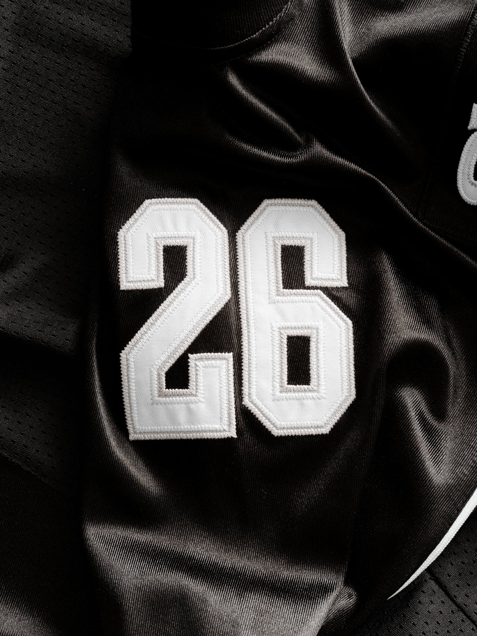 Black Signature Jersey by Sweats UK, laid flat showing front design and soft fabric texture.