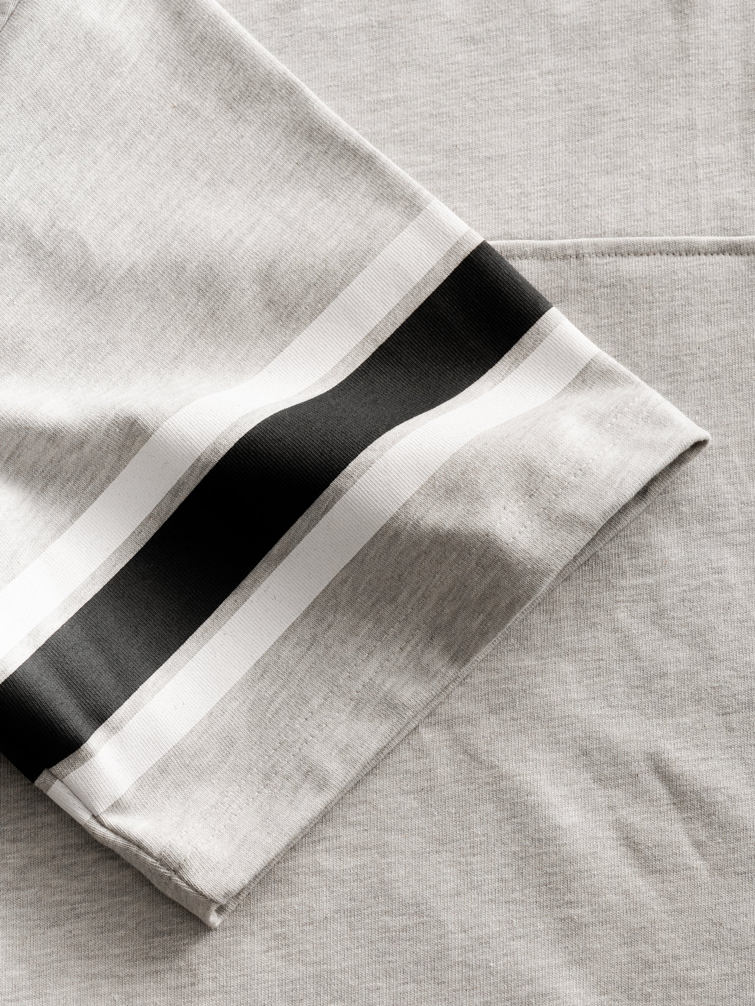 Light gray jersey short sleeve T-shirt from Sweats UK, with a classic fit and minimalist design, laid flat on a white background.