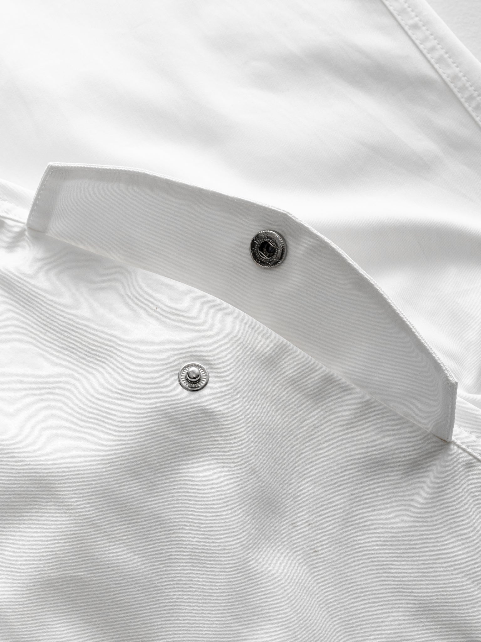 White V3 Flight Shorts by Sweats UK laid flat showing lightweight fabric and elastic waistband for active wear.
