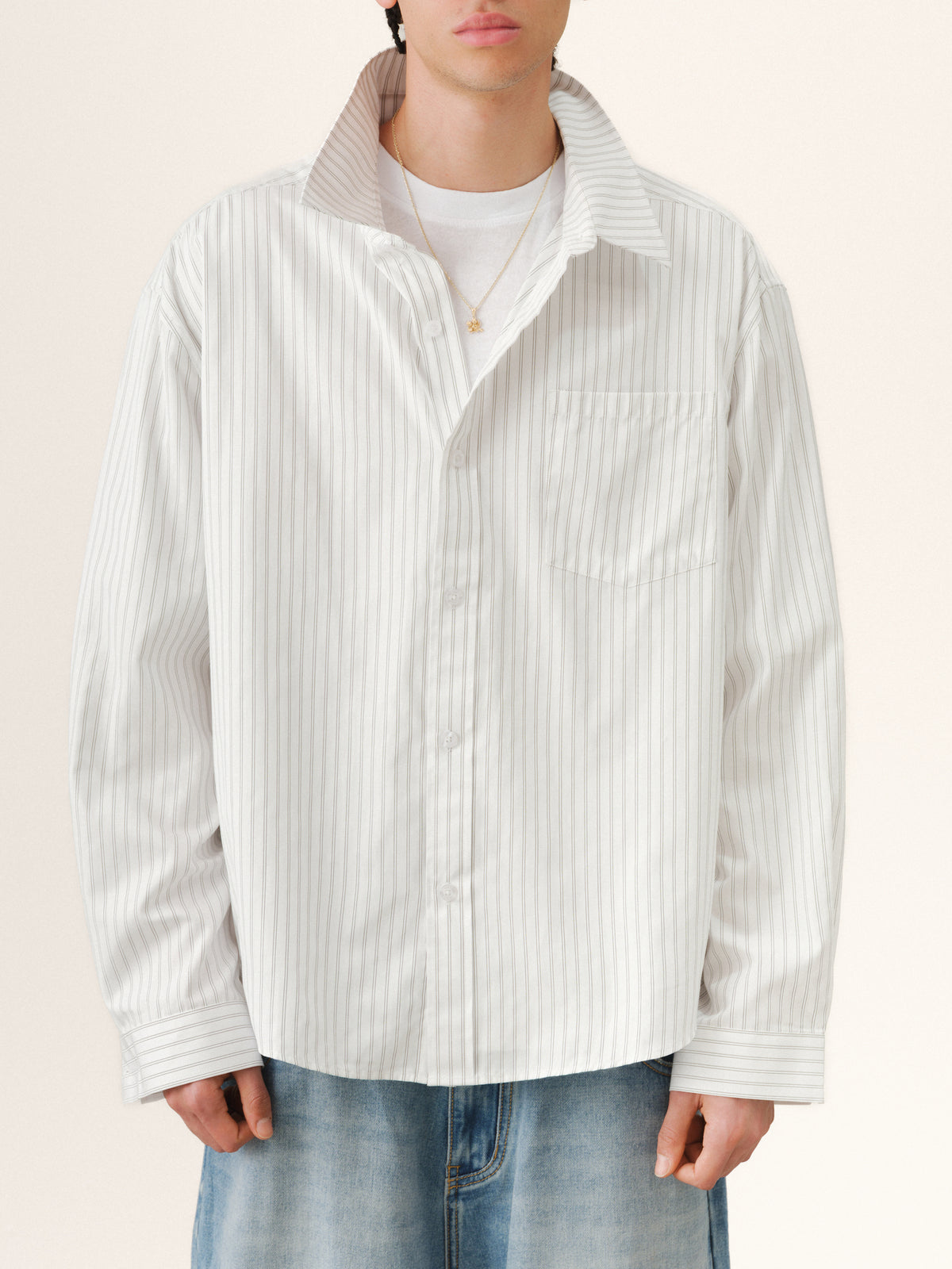 White striped button-up shirt by Sweats UK with a classic collar and long sleeves, displayed flat on a white background.