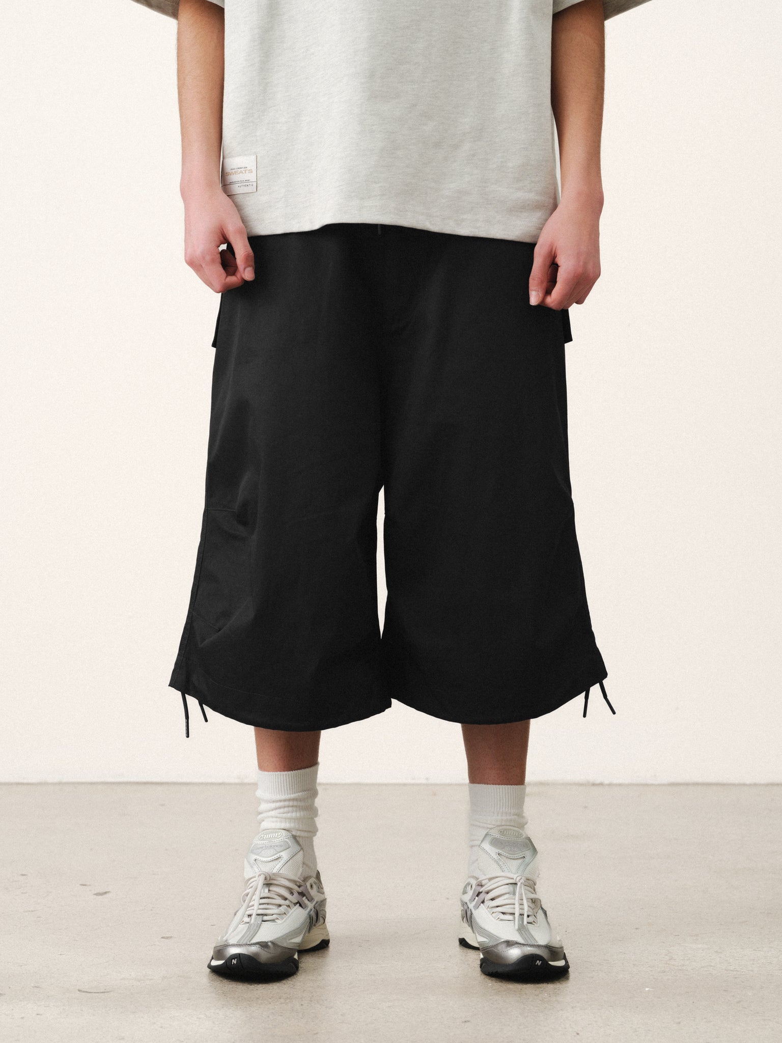 Black V3 Flight Shorts by Sweats UK, featuring lightweight fabric and sporty design, shown laid flat on a neutral background.