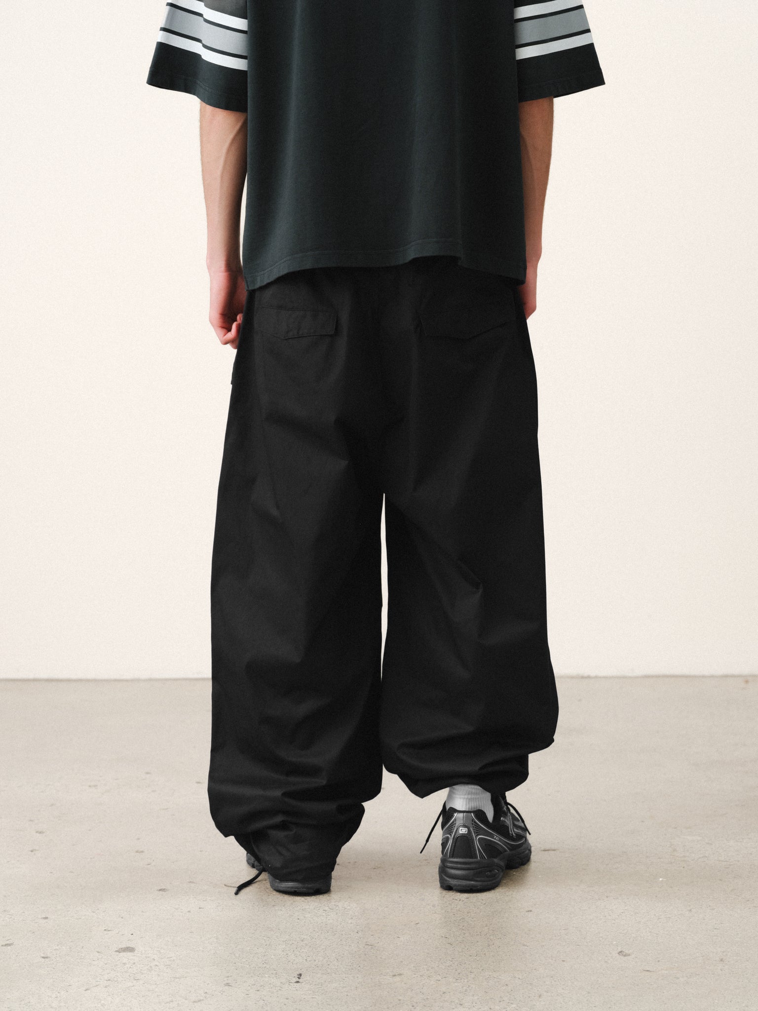 Black V3 Flight Pant by Sweats UK, featuring relaxed fit and sporty design, shown on a model against a neutral background.