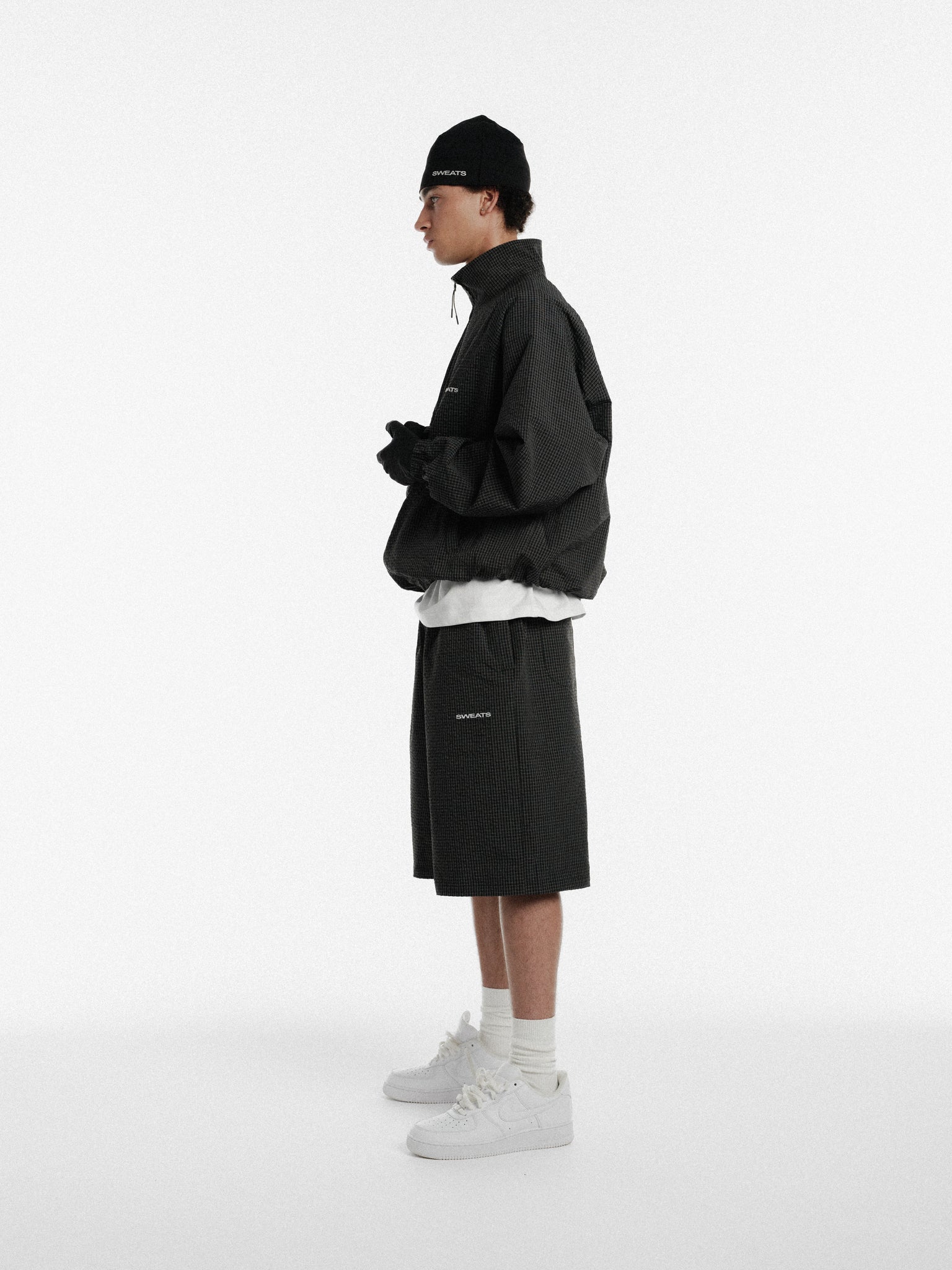 Black and white checkered sweat shorts from Sweats UK, casual athletic style with elastic waistband and relaxed fit.