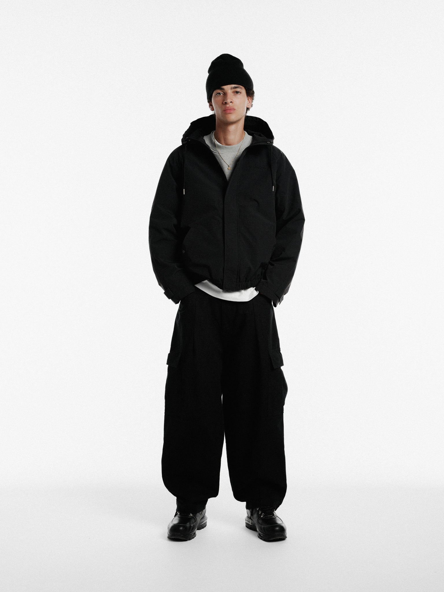 Black ARC jacket by Sweats UK, shown on a hanger, featuring a sleek design with zip closure and modern style.