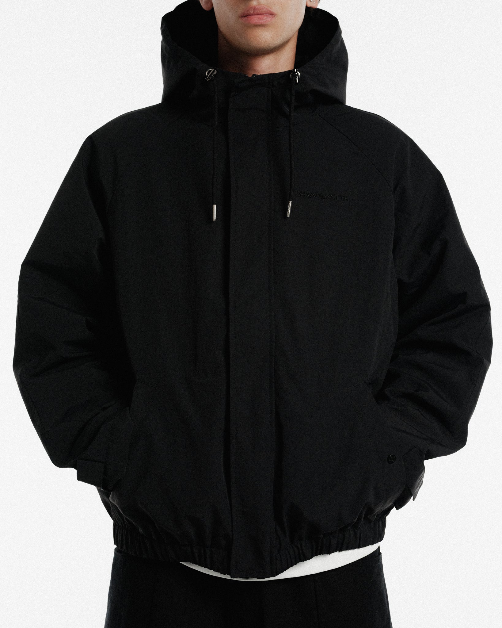 Black ARC Jacket by Sweats UK, featuring a sleek winter design with a stylish fit and durable fabric for cold weather.