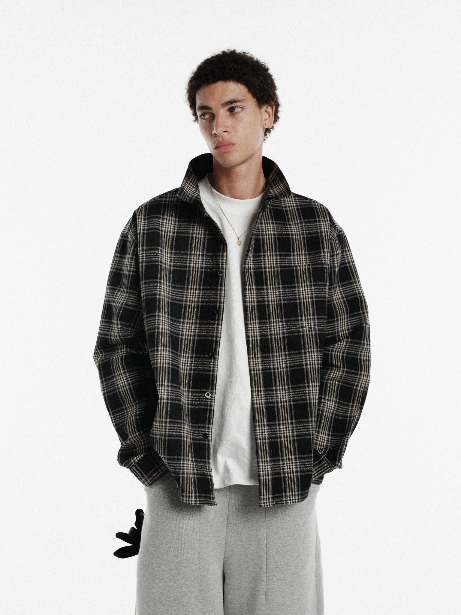 Black long-sleeve flannel shirt by Sweats UK, shown with button-up front and classic collar.